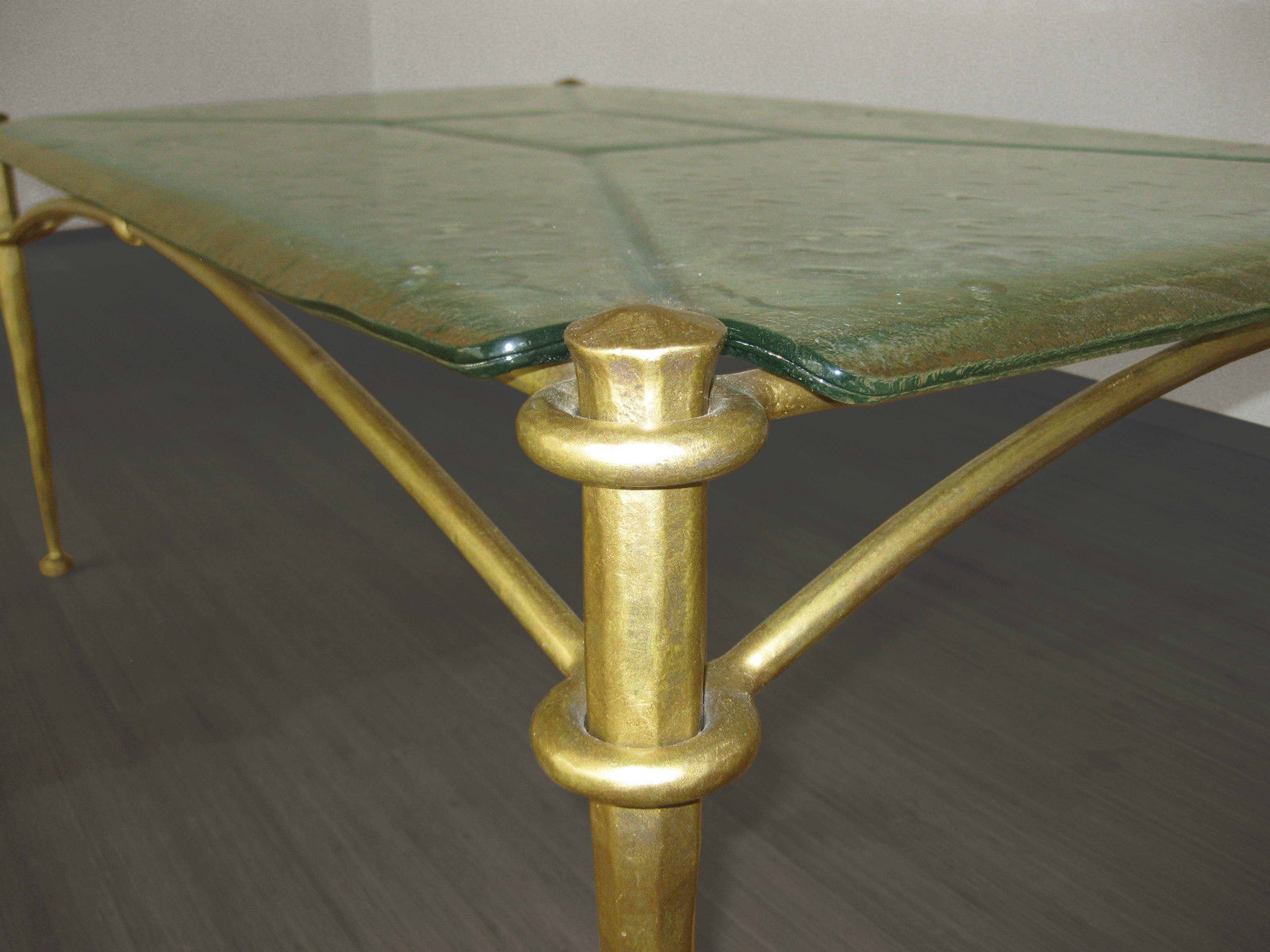 A foraged bronze coffee table with textured glass top.

Italian, Circa 1940's
