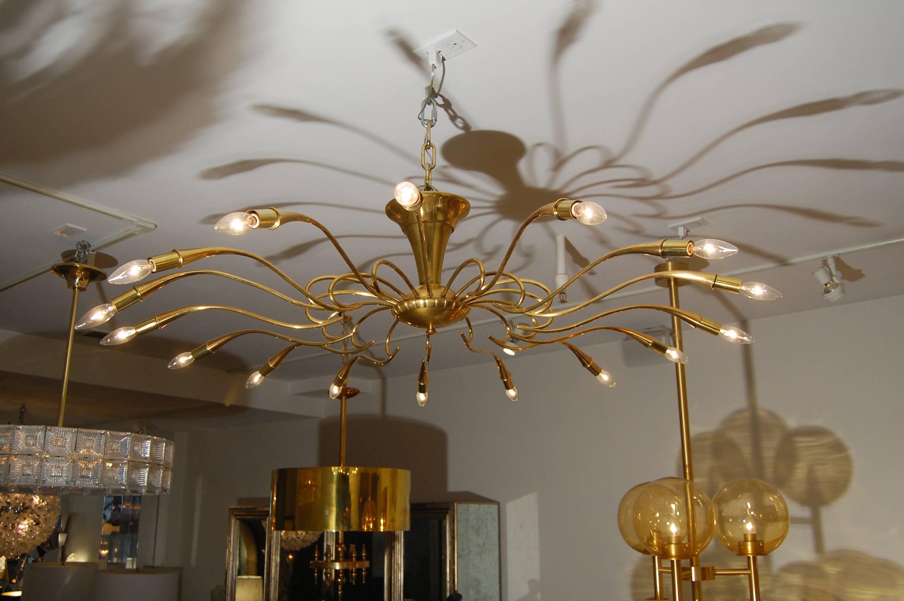A large brass ceiling fixture with multiple curvaceous arms by Oscar Torlasco, Italian, circa 1960s.

