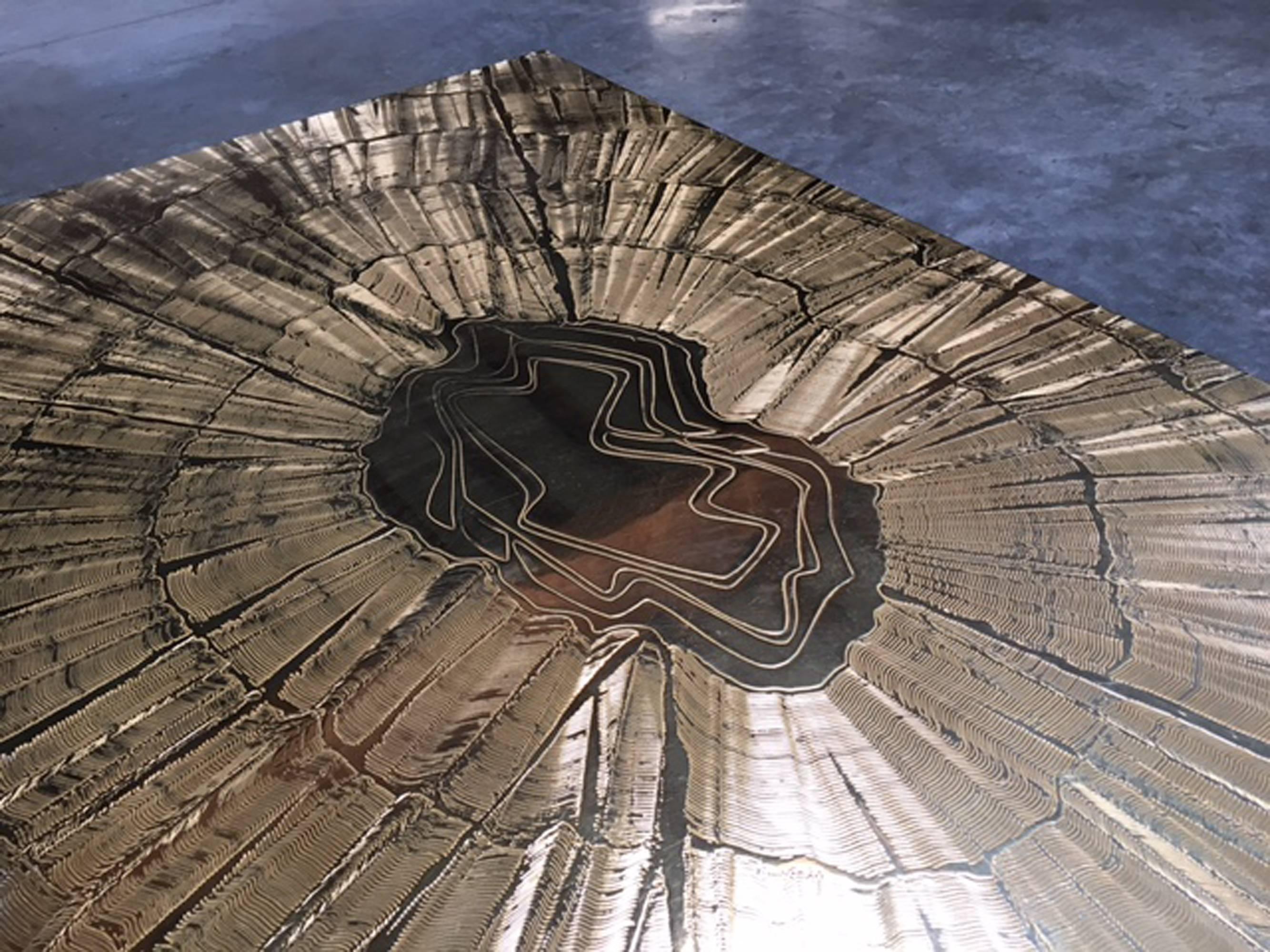 An etched bronze starburst coffee table resting on two blackened multi legged bases by Lova Creation.

Belgian, Circa 1970's

