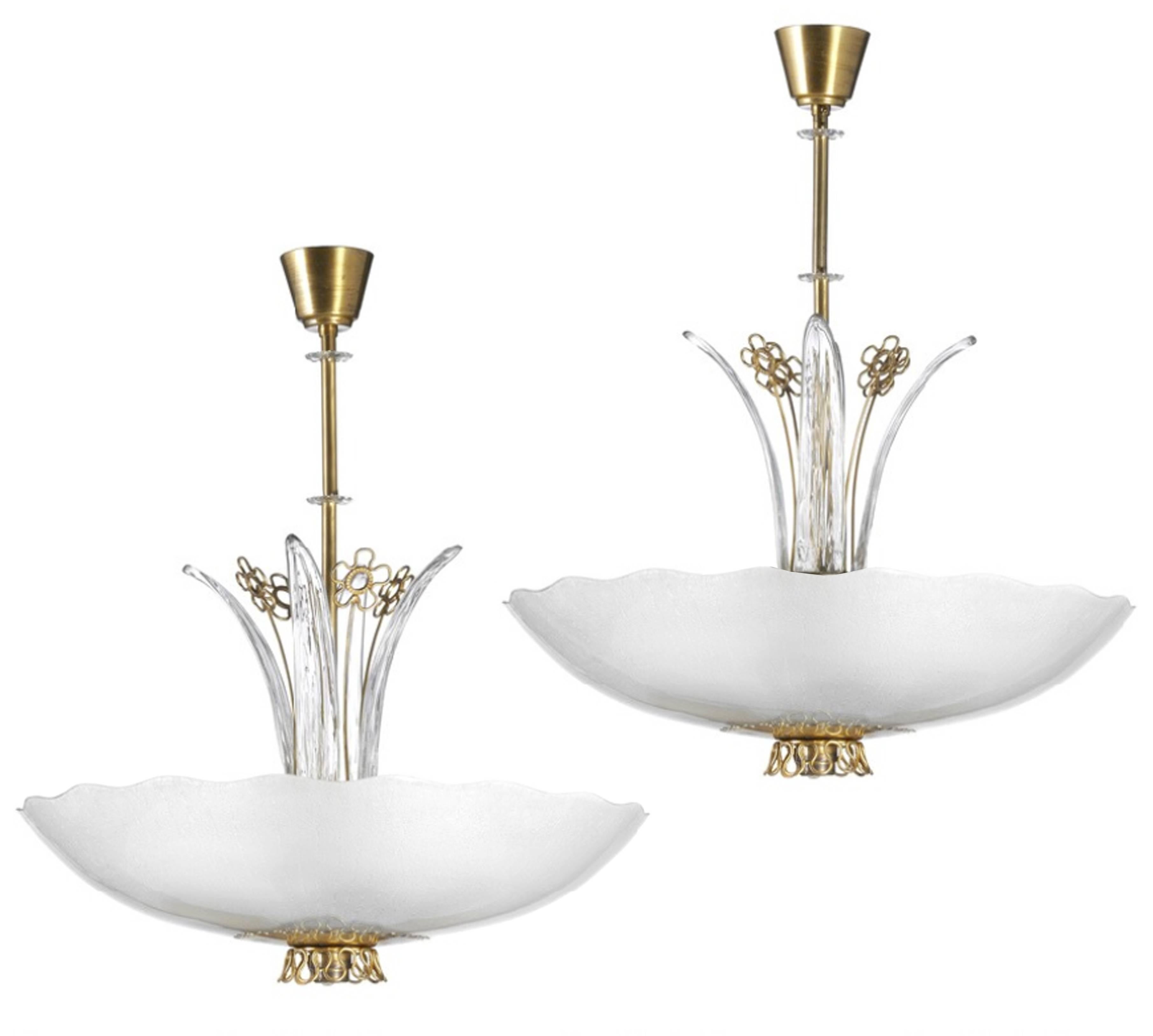 A pair of glass chandeliers with scallop edges and decorative brass and glass details by Orrefors.

Swedish, Circa 1940's