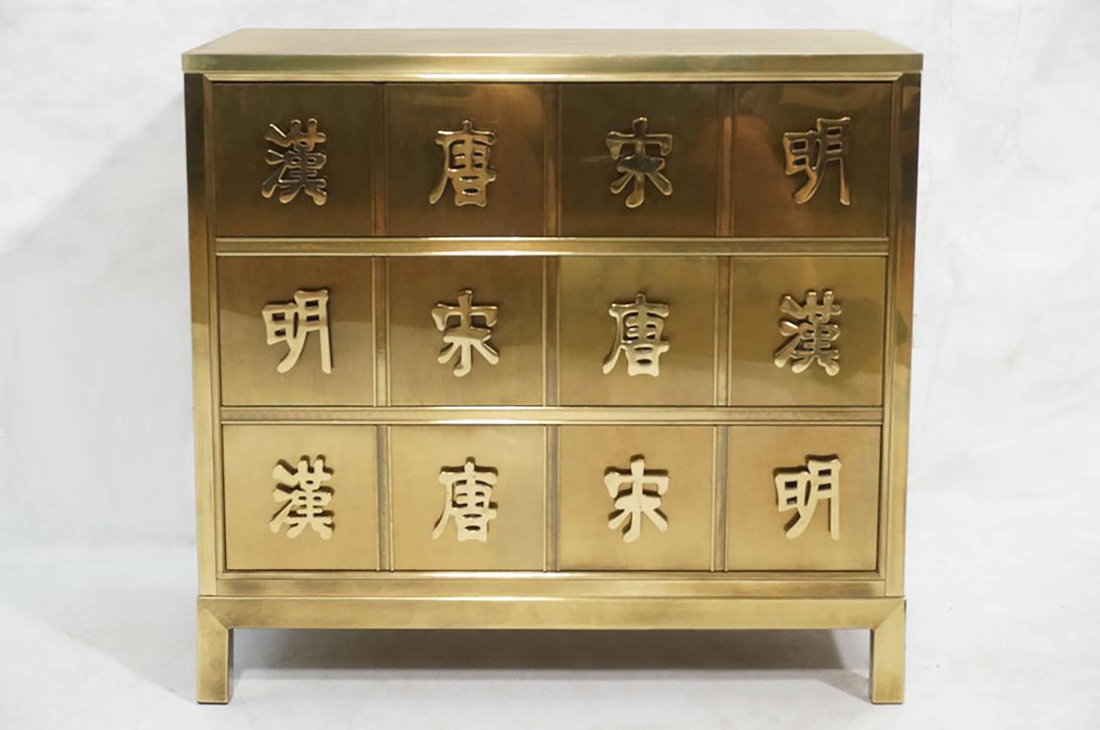 A three-drawer brass dresser with Asian symbols by Mastercraft.

American, Circa 1970's.