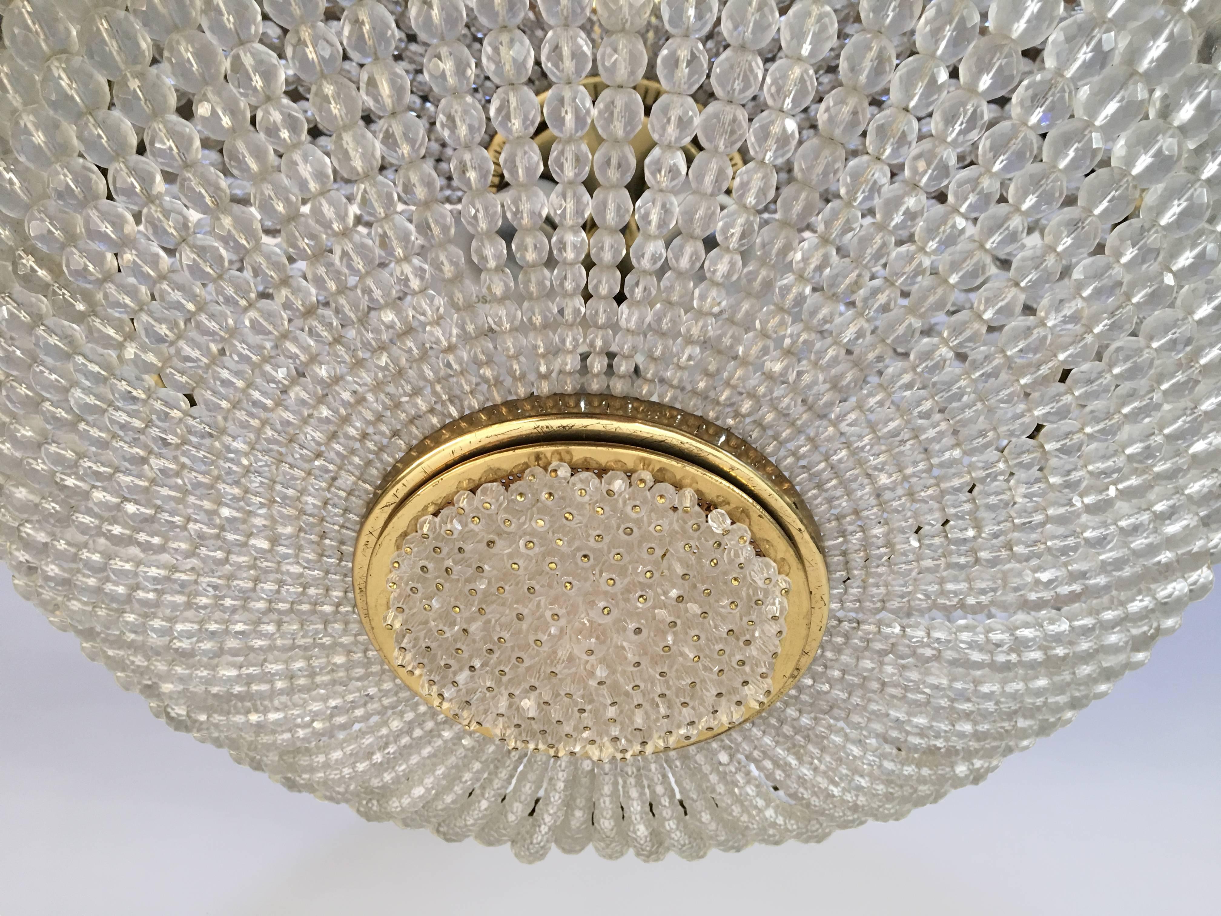 A brass chandelier with faceted glass beads by J.L Lobmeyr.

Austria, Circa 1960's