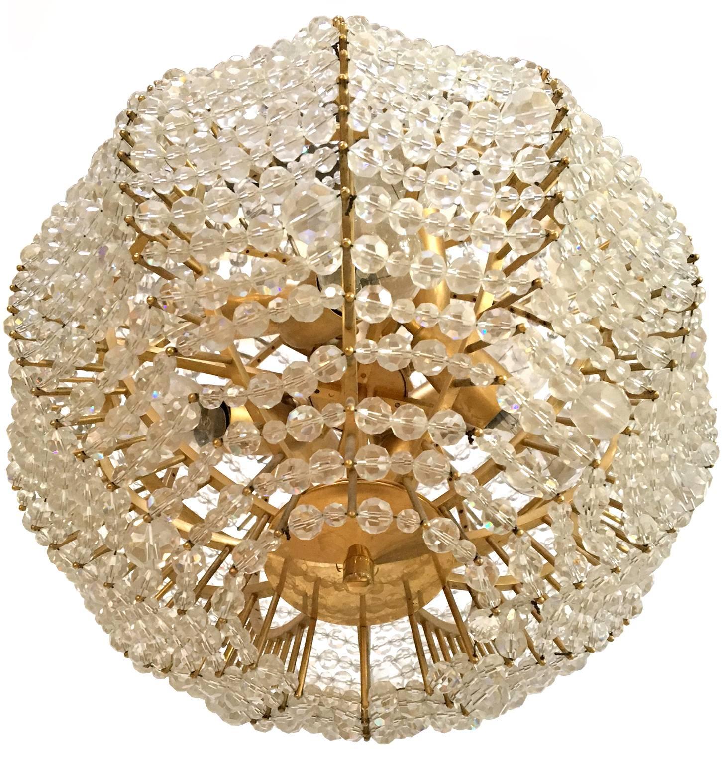 An original gilt brass supernova chandelier with hand-cut glass beads.

Made in the 1960s by Vienna based company Bakalowits & Sohne.