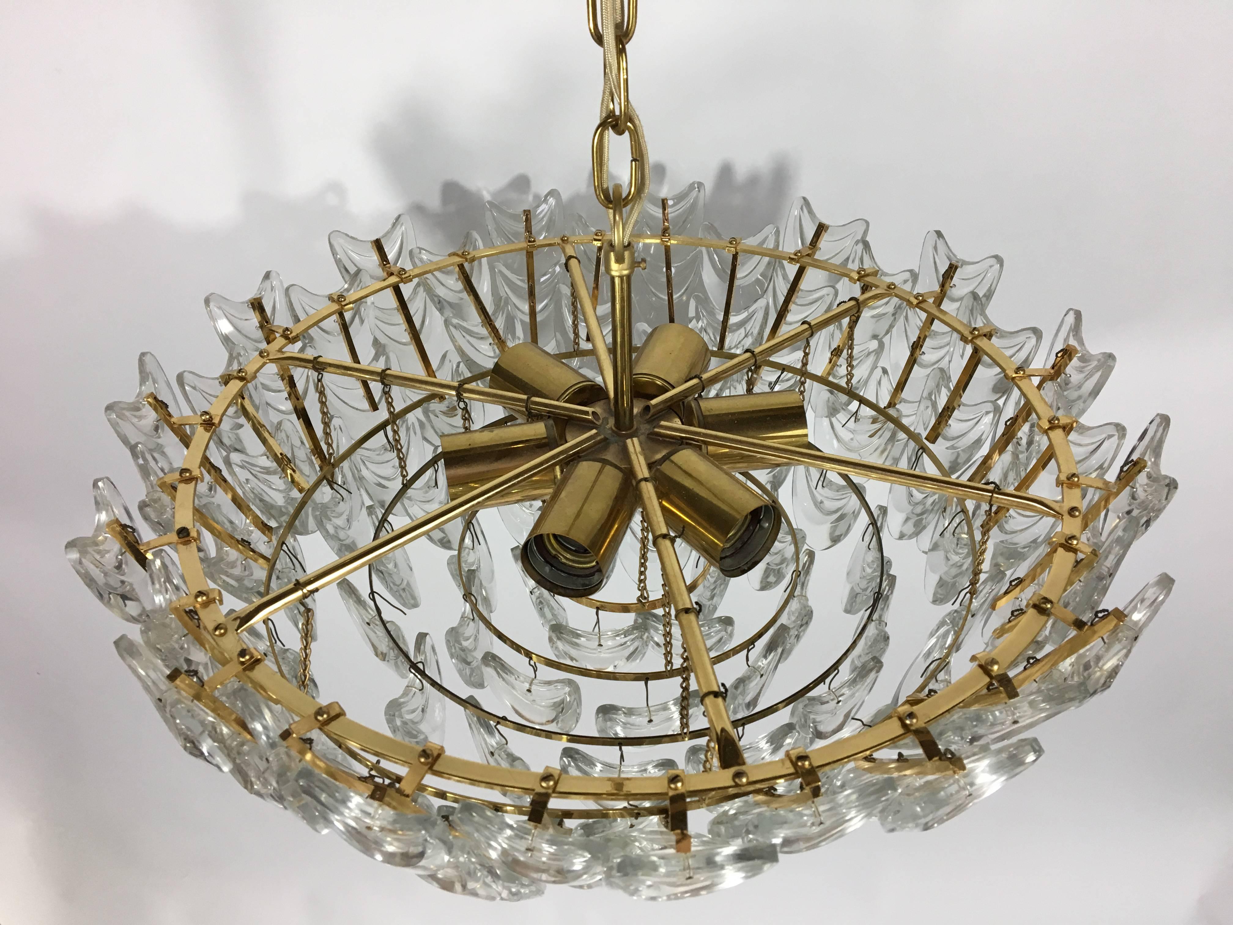 A gilt brass chandelier with multiple pieces of glass.

German, Circa 1960s.
