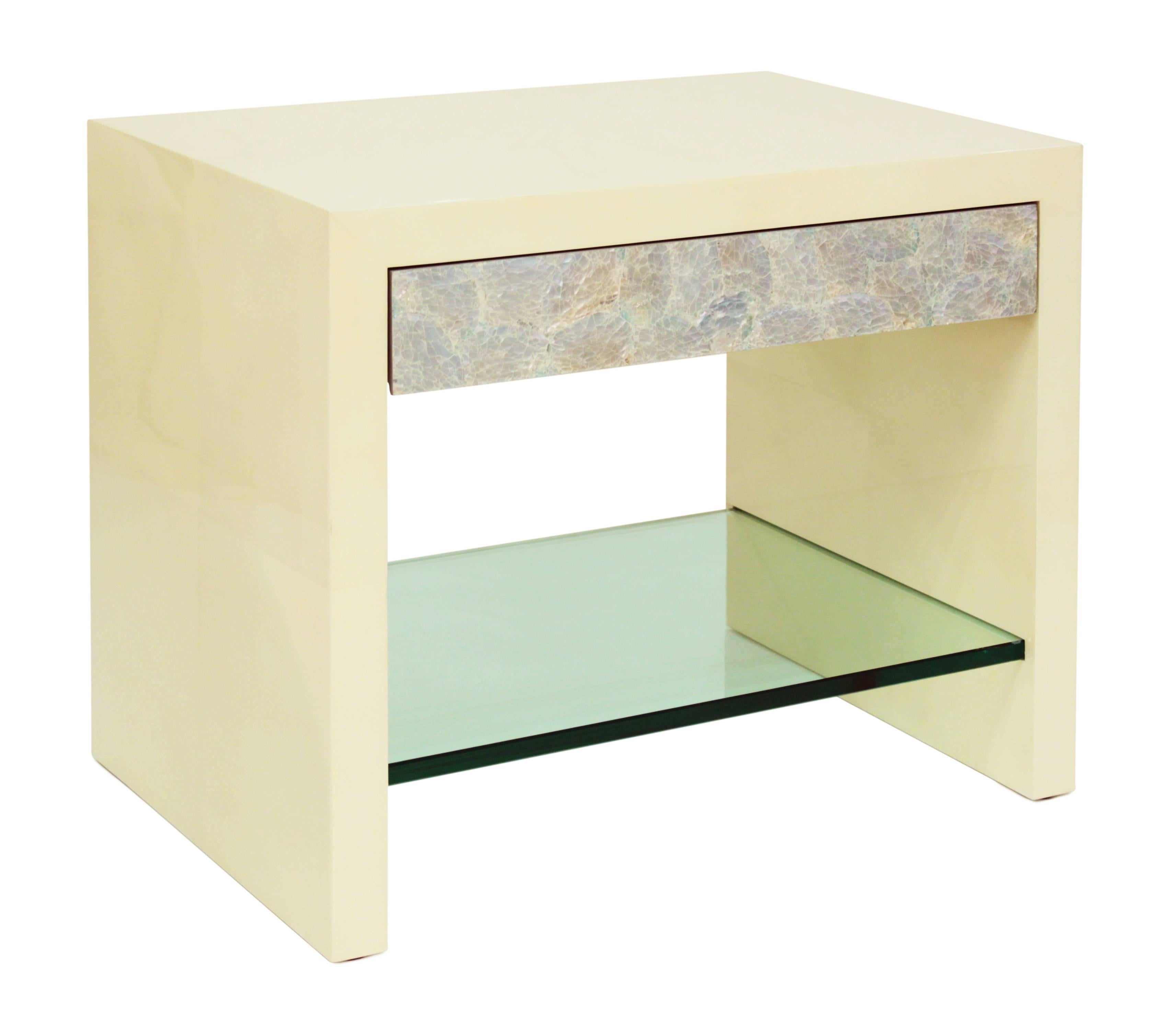 
Pair of “Pearl Front Bedside Tables” covered in lacquered goatskin with drawer in mother of pearl and lower glass shelf by Evan Lobel for Lobel Originals. These were custom-made in the most meticulous way.
      