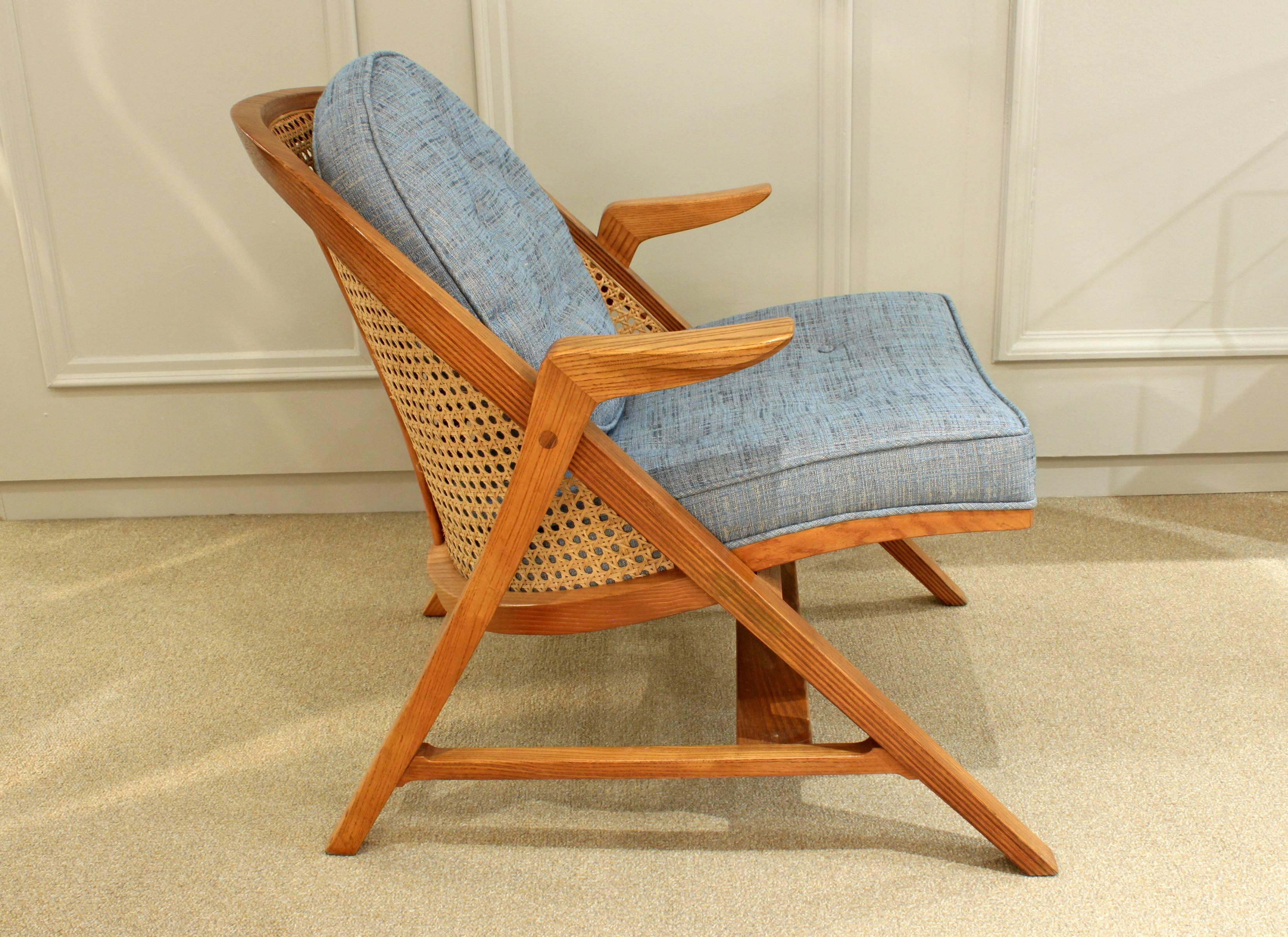 Lounge chair model No. 5700 in laminated ash with cane back and upholstered seat with back pillow by Edward Wormley for the Janus Collection, American, 1957. This chair, which is very craft intensive, is a great example of Wormley's designs.