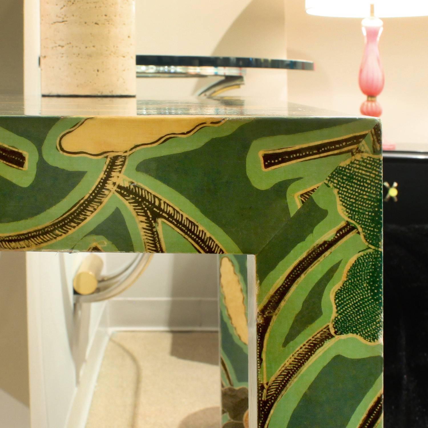 Game table clad in lacquered floral batik by Karl Springer, American, 1970s. This is an early example of his work.