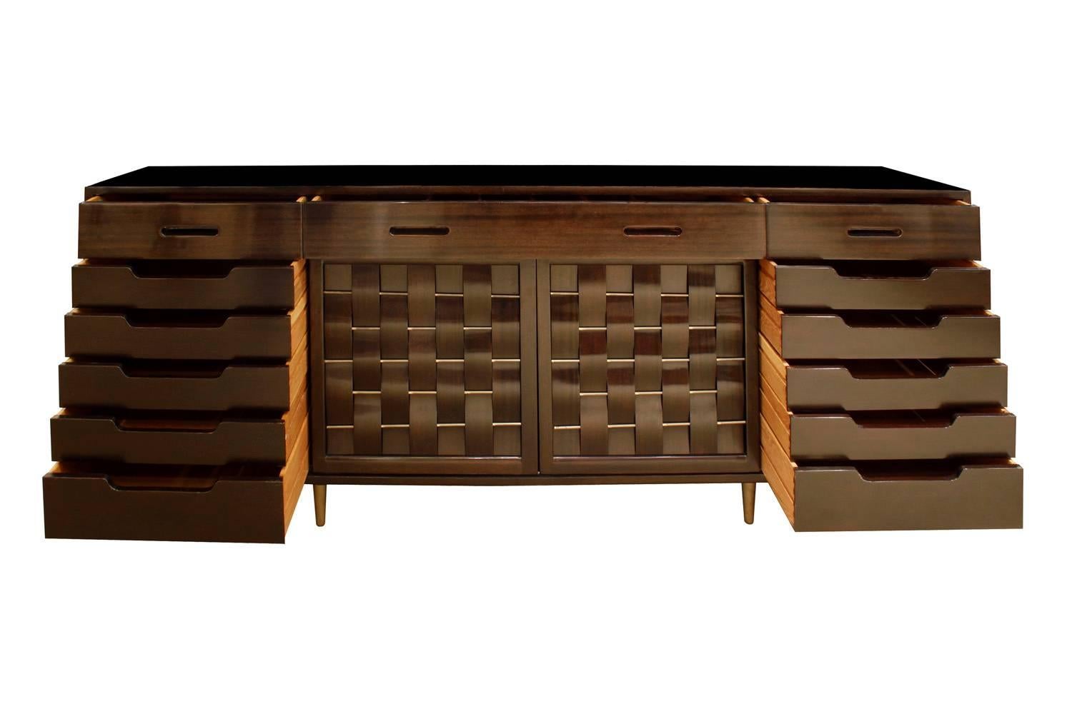 Sideboard model No. 4453 in mahogany with four doors, slats woven over rods, and conical brass legs designed by Edward Wormley for Dunbar, American, 1940s (signed with metal label in drawer).