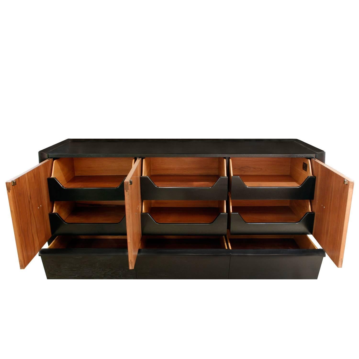 Chic credenza with ebonized case and walnut doors with copper pulls with drawers below, Italian, 1940s.