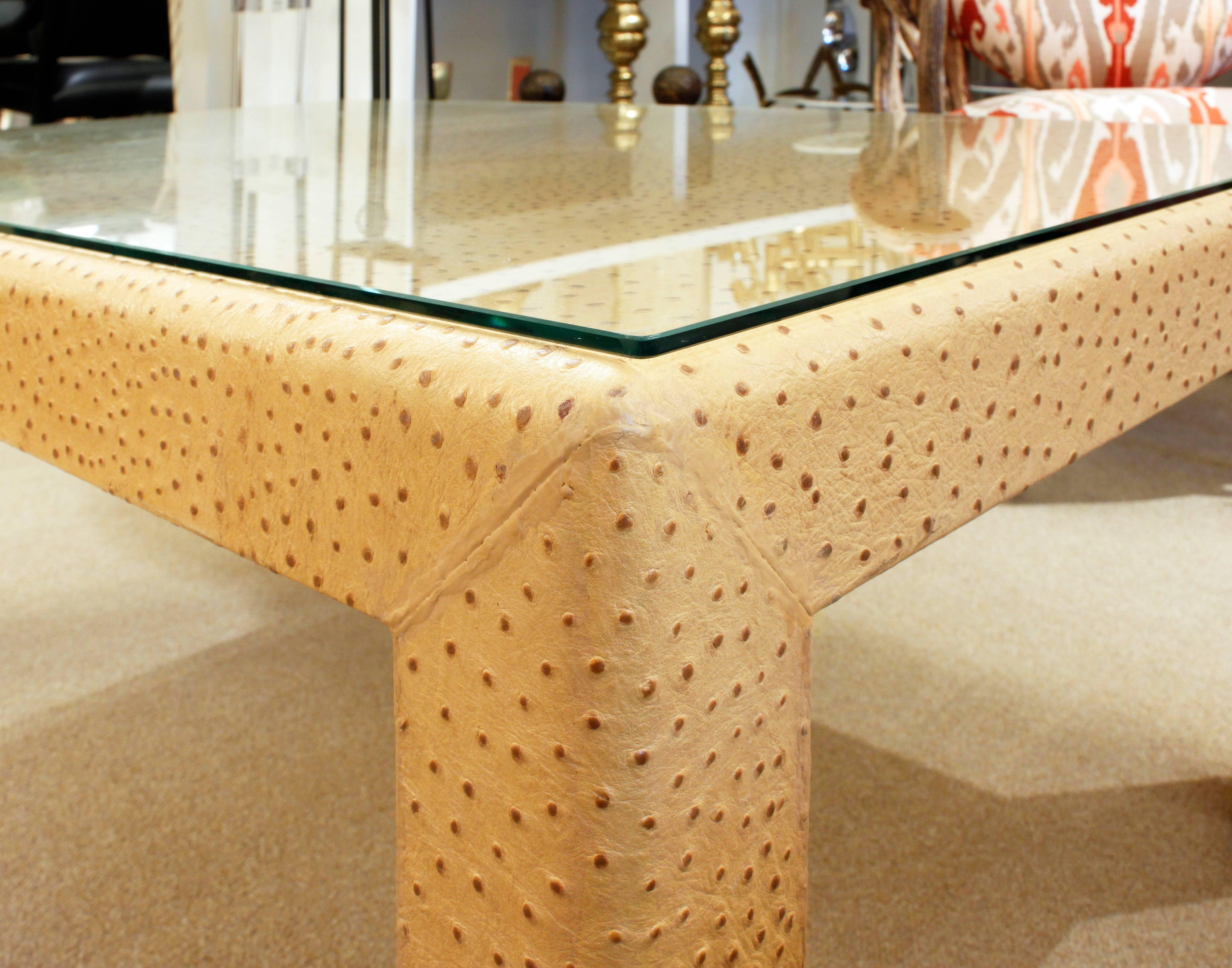Elegant coffee table covered in ostrich skin with glass top by Karl Springer, American 1970's (signed with metal Karl Springer label on bottom).  This table is a beautiful example of Springer’s superb craftsmanship.
 