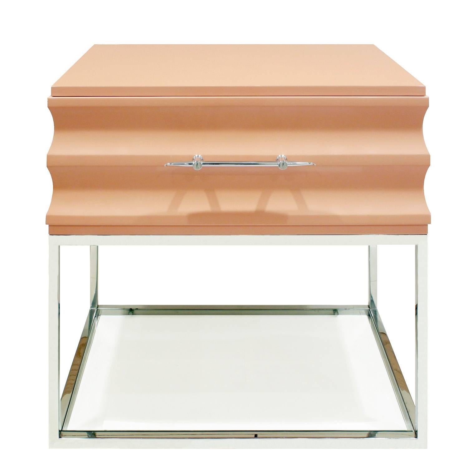 Pair of sculpted bedside tables, lacquered with exquisite polished chrome pulls and bases with inset glass shelves at bottom by Tommi Parzinger for Parzinger Originals, American, 1960s (branded “Parzinger Originals” in drawers).
 