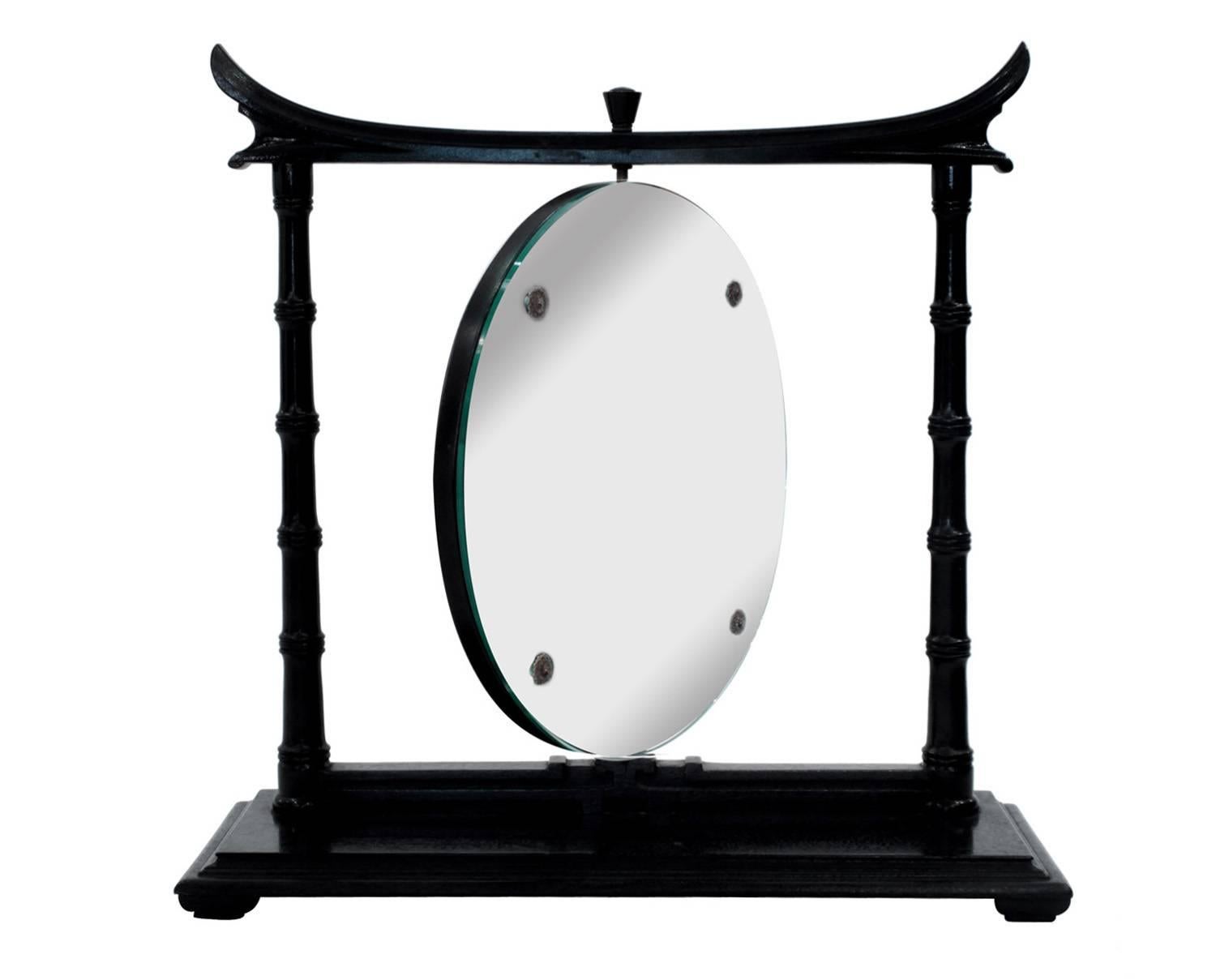 Vanity or tabletop revolving mirror in ebonized mahogany with bamboo motif by James Mont, American, 1950s.