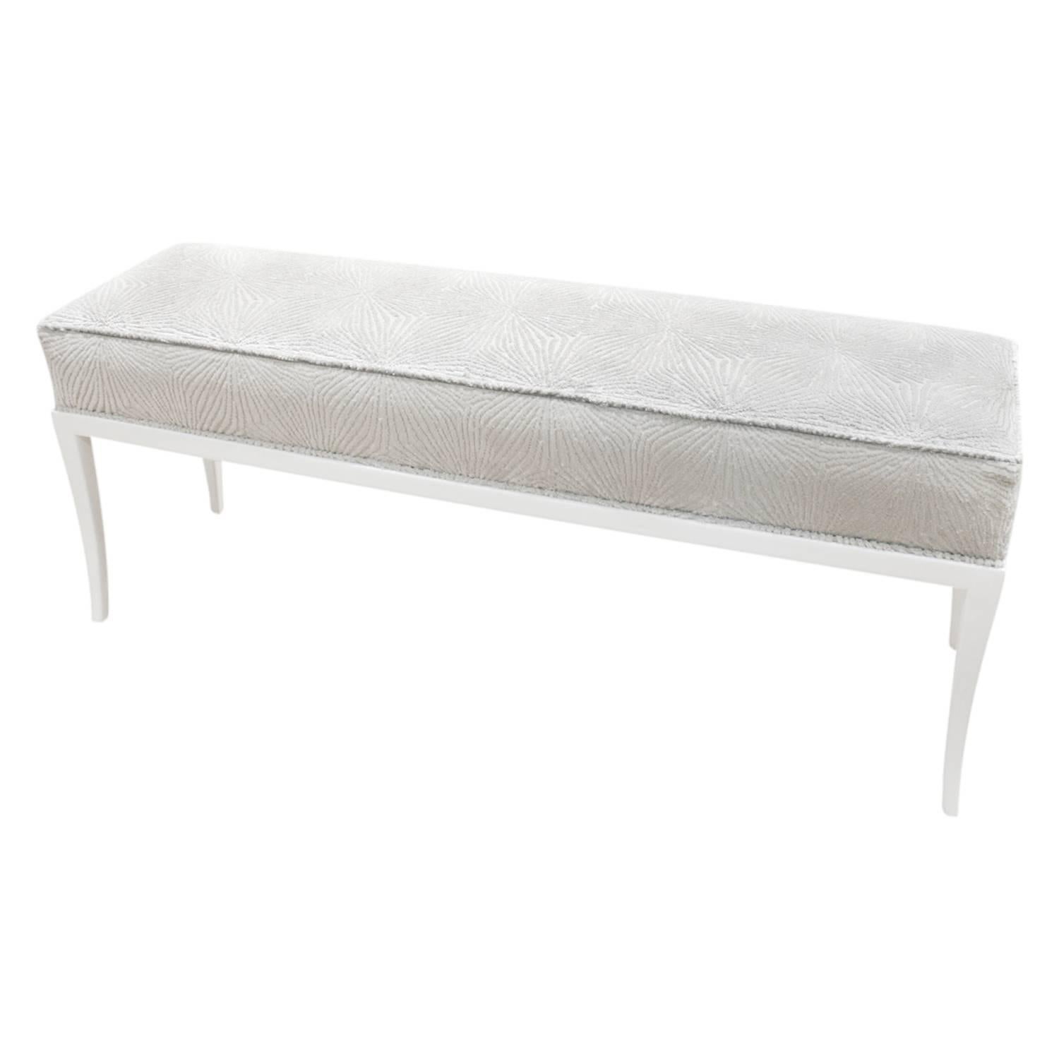 Elegant bench no. 313, white lacquered mahogany base with tapering legs and upholstered seat, by Tommi Parzinger for Parzinger Originals, American 1950s. This is newly upholstered by Lobel Modern.