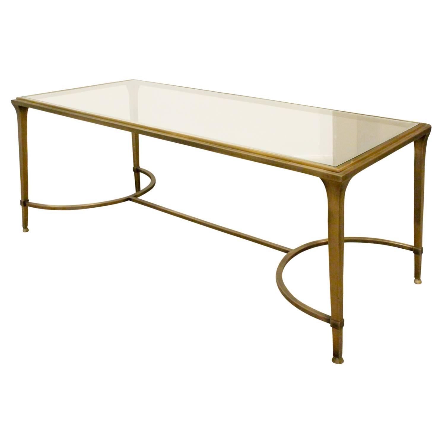 Coffee table in satin bronze with polished bronze accents and inset glass top, American, 1960s.