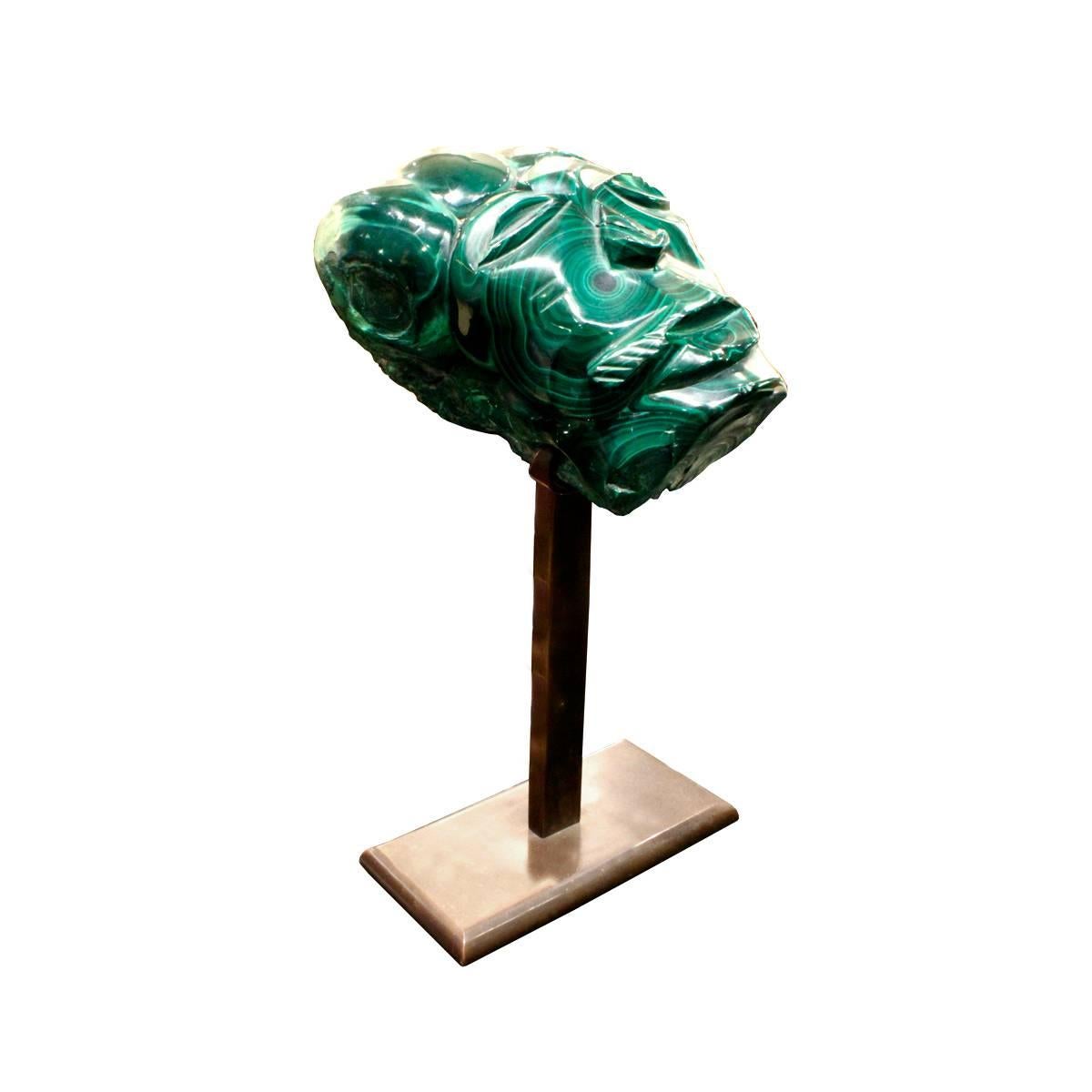 Hand-carved and polished malachite head on custom bronze base with felt underside by Karl Springer, American, 1970s.