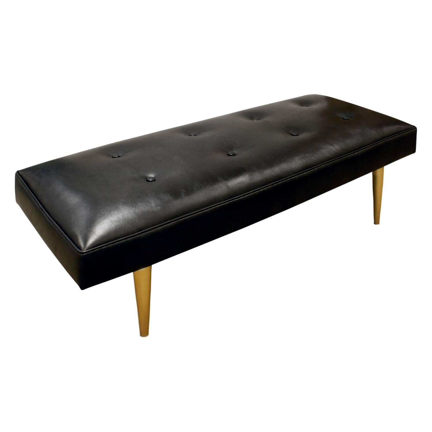 Bench with newly upholstered black leather seat and conical brass legs by Milo Baughman for Thayer Coggin, American, 1950s (label on bottom of bench, see photo).