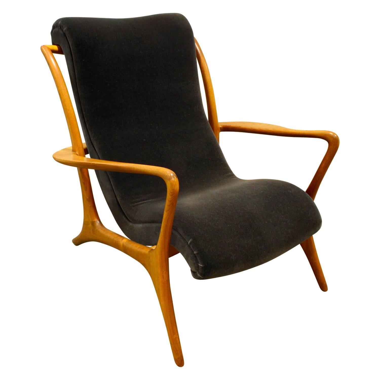 Sculpted walnut Contour chair newly upholstered in dark blue velvet by Vladimir Kagan, American, 1950s. This is an iconic Kagan design with meticulous craftsmanship.