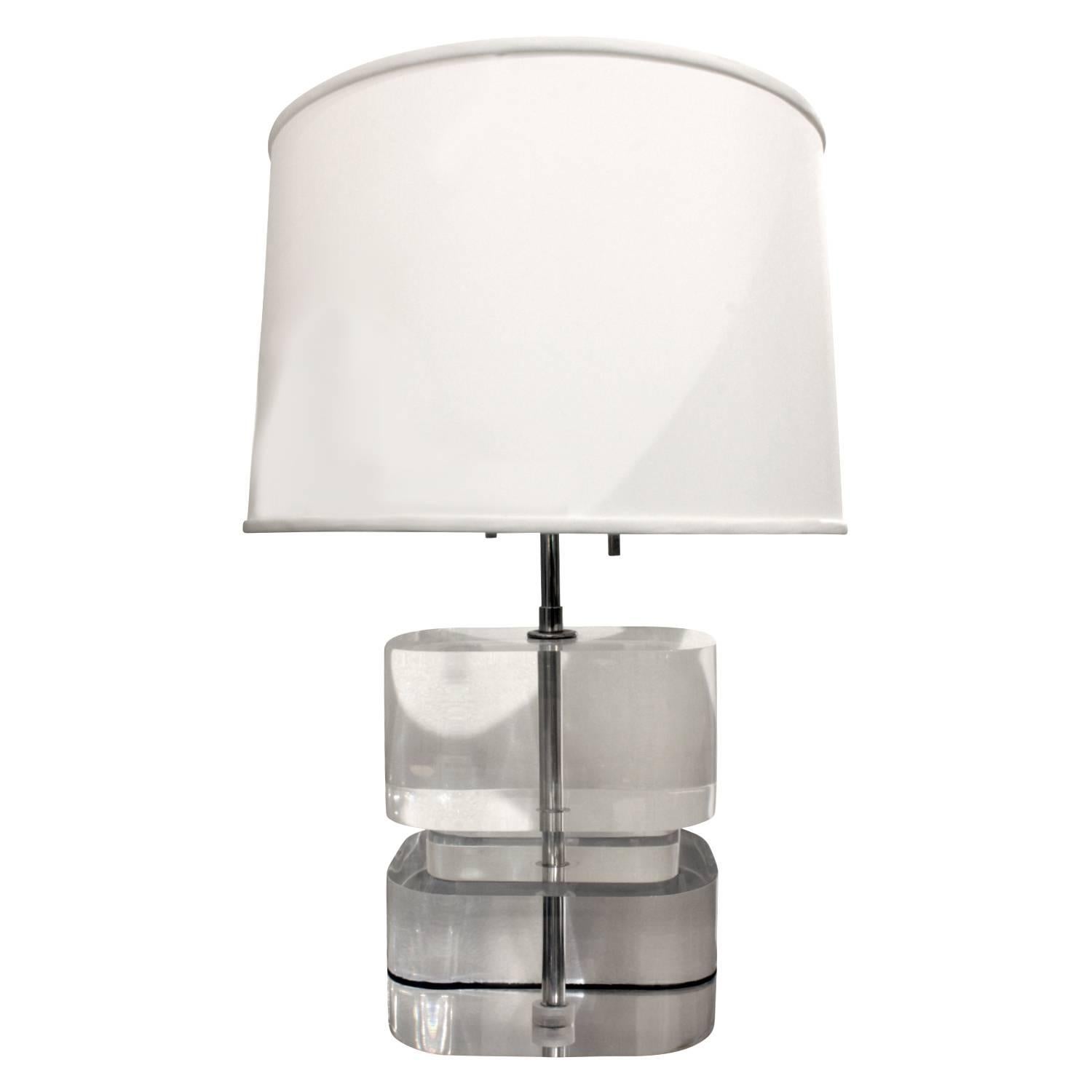 Pair of two-tier table lamps with solid thick clear Lucite block design by Karl Springer, American 1970s. Signed “Karl Springer” on bottom side. These are rare and exceptional table lamps. Overall height is adjustable.