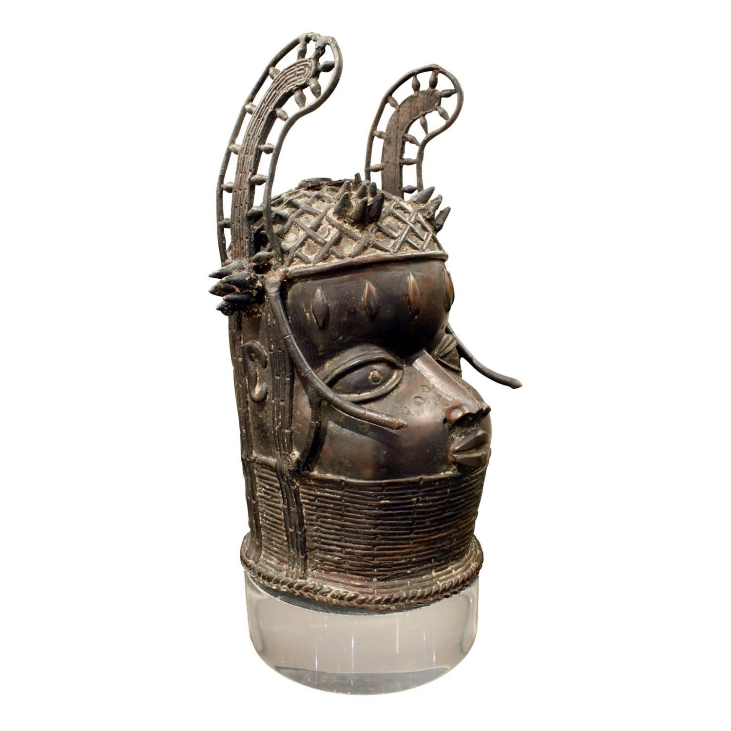 Authentic bronze Benin head on a custom Lucite base by Karl Springer, American 1970s (comes with a Letter of Authentication from Karl Springer's former Director of Design). Springer often incorporated fine works of ethnic art into his designs.