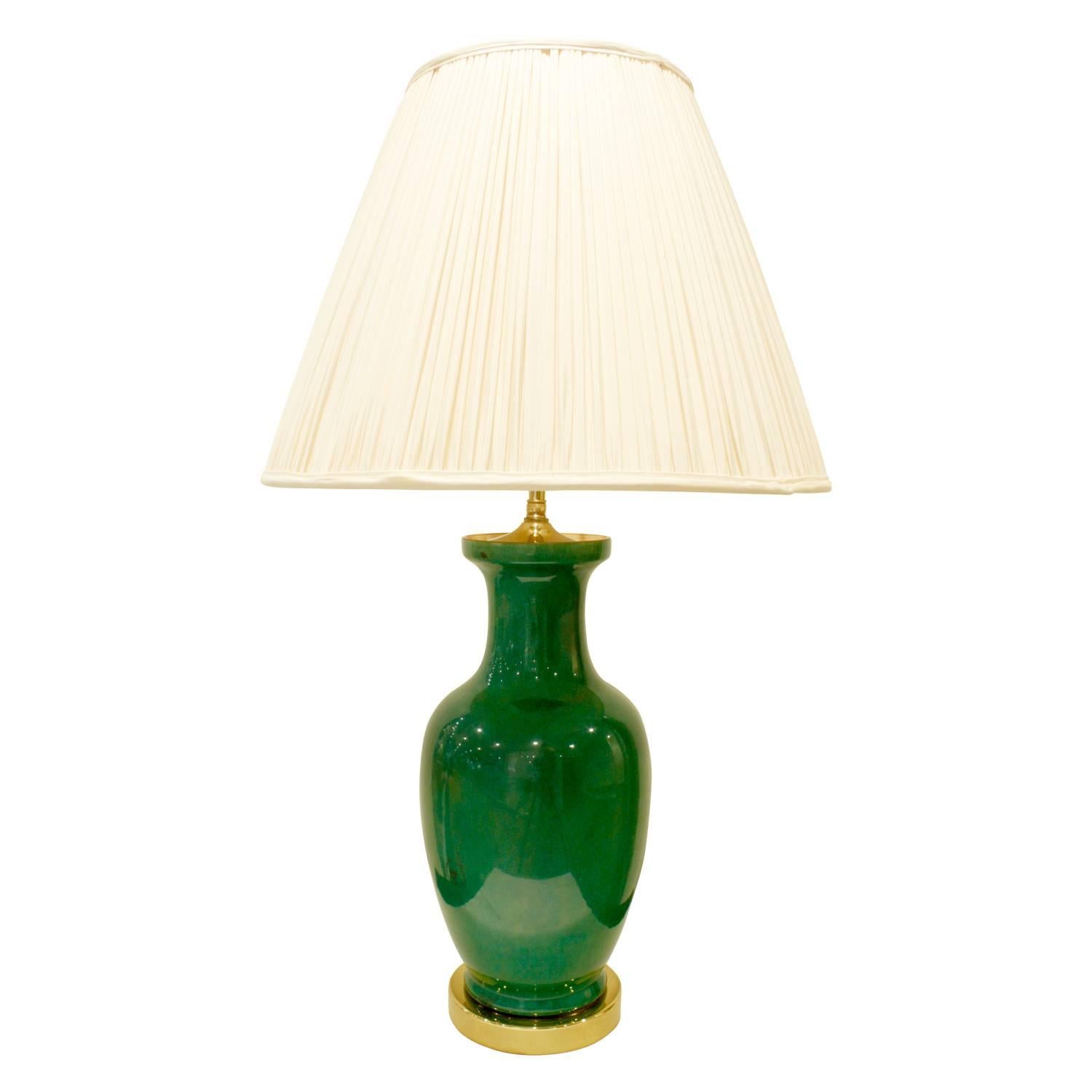 Pair of studio made emerald green porcelain table lamps with craquele glaze with brass bases and custom fittings, American 1960s.