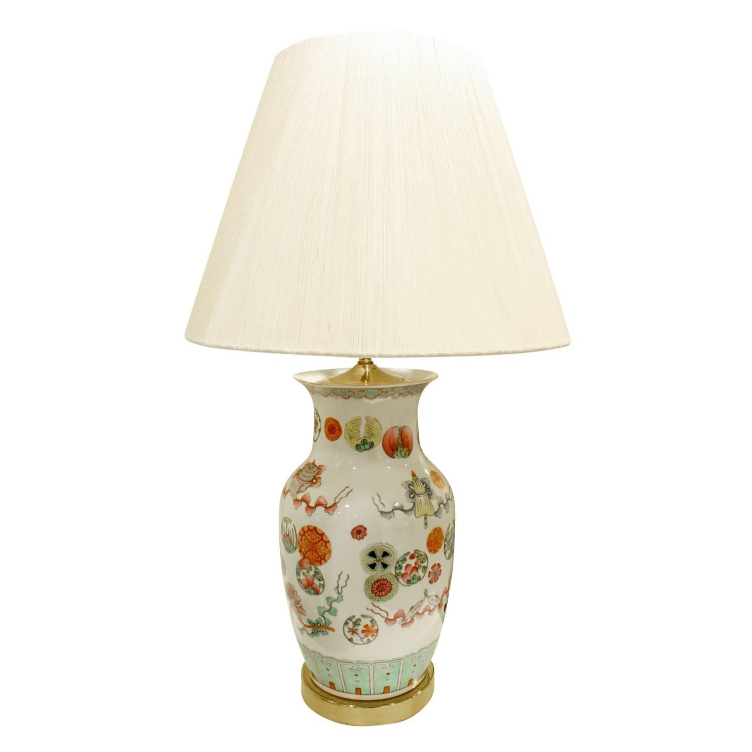 Exceptional hand-painted porcelain table lamp with flowers, medallions and geometric decoration with brass base and custom fittings, China, 1960s.