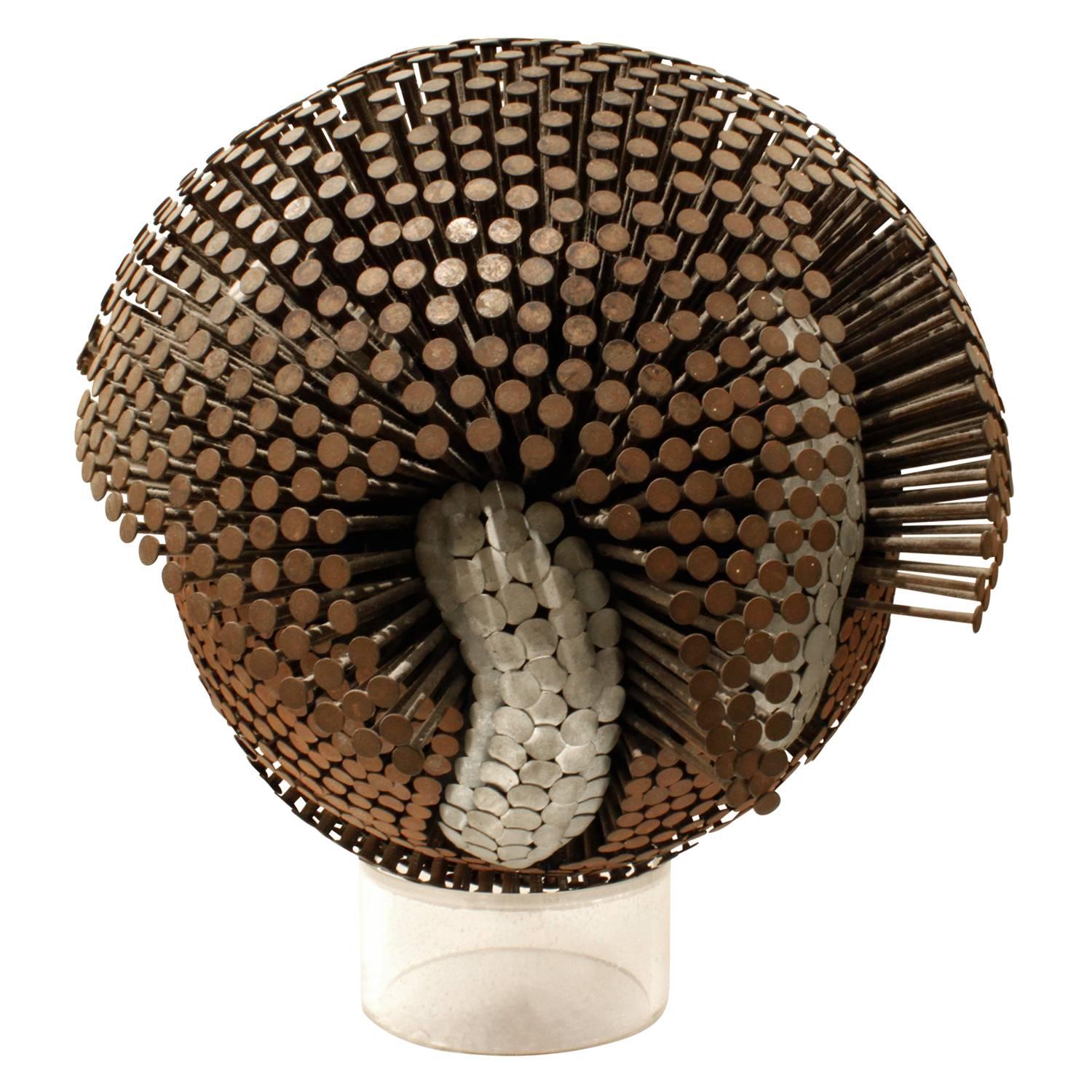 Sculpture composed of rusted and steel nails, spherical on a Lucite base, sold by Karl Springer, American, circa 1975. Comes with Authentication by Karl Springer's Director of Design. This sculpture is amazing.