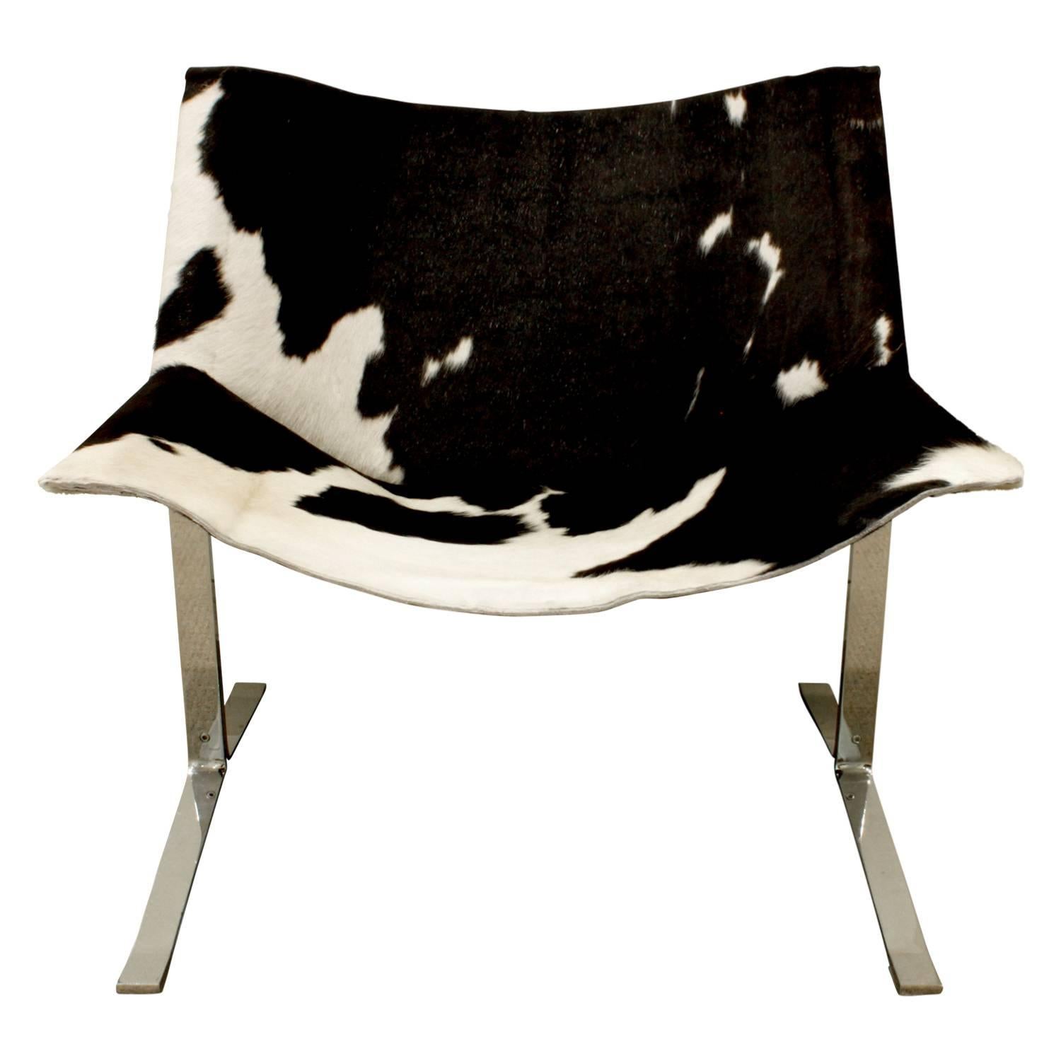Pair of sling chairs in polished steel with new cow hide seats and backs by Clemente Meadmore, American, 1963. Newly upholstered by Lobel Modern.
