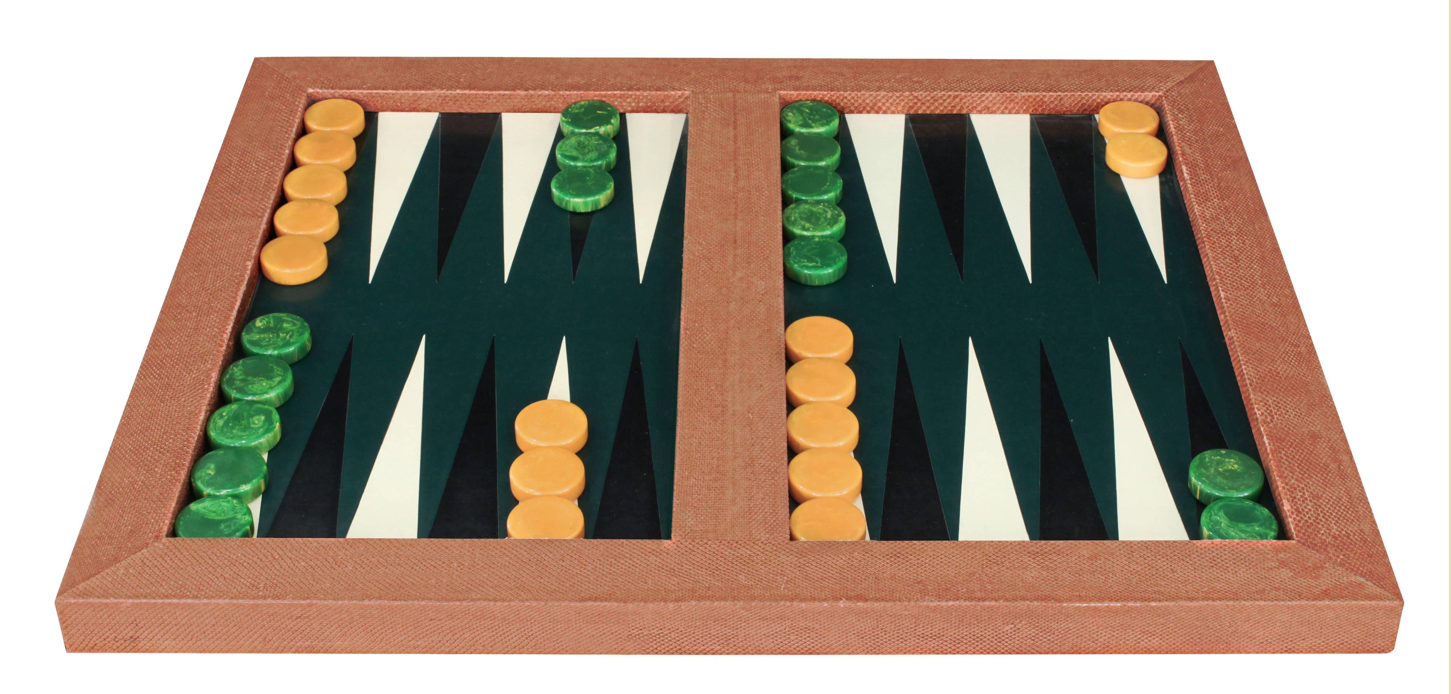 Backgammon game board covered in whip snake with hand-stitched leather board, matching cup and original game pieces by Karl Springer, American 1970s.
 