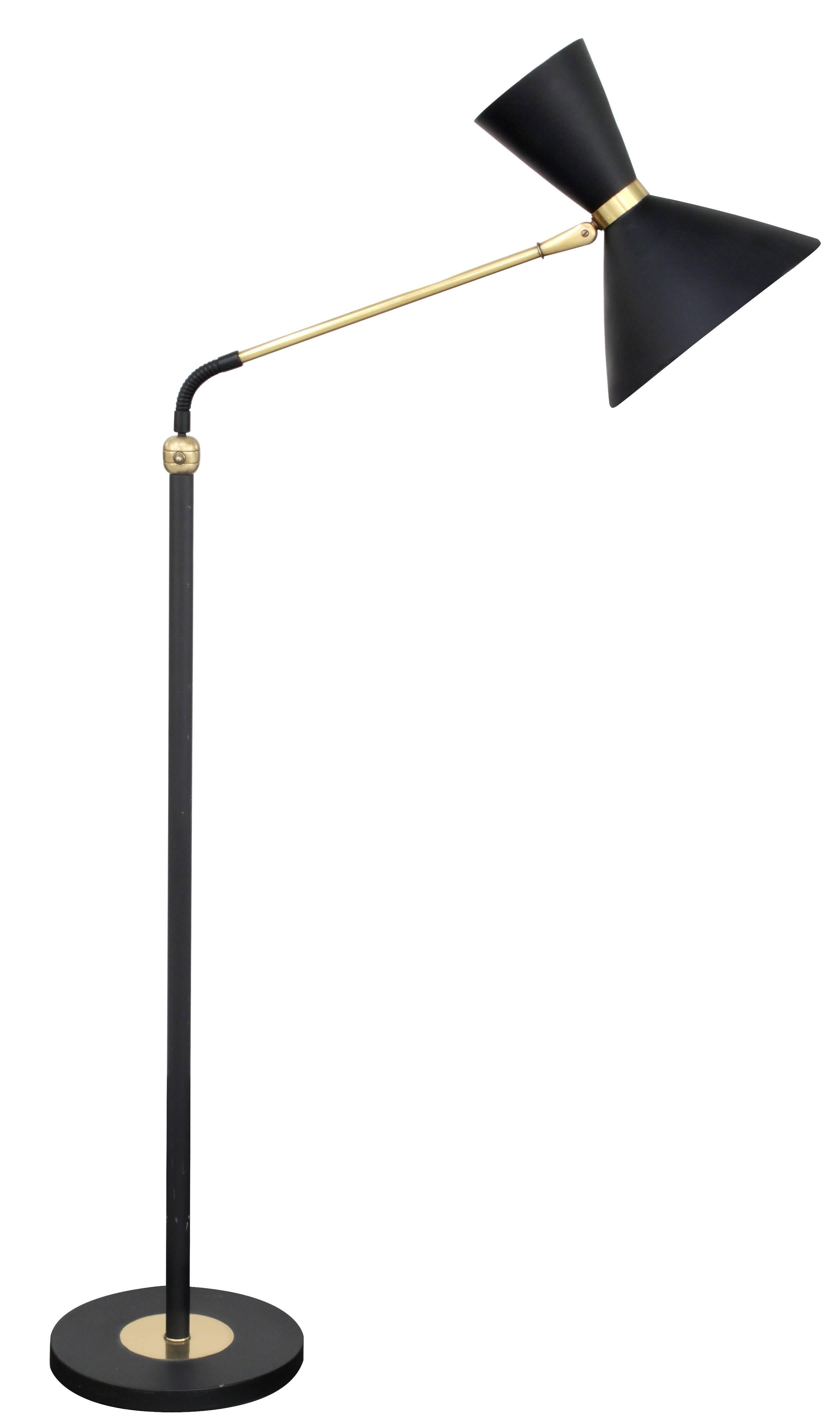 Floor lamp in brass with black shade (up and down lighting) attributed to Stilnovo, Italian, 1950s. Lamp is adjustable, completely upright it is 65 inches tall, angled all the way down it is 47 1/2 inches tall.
 