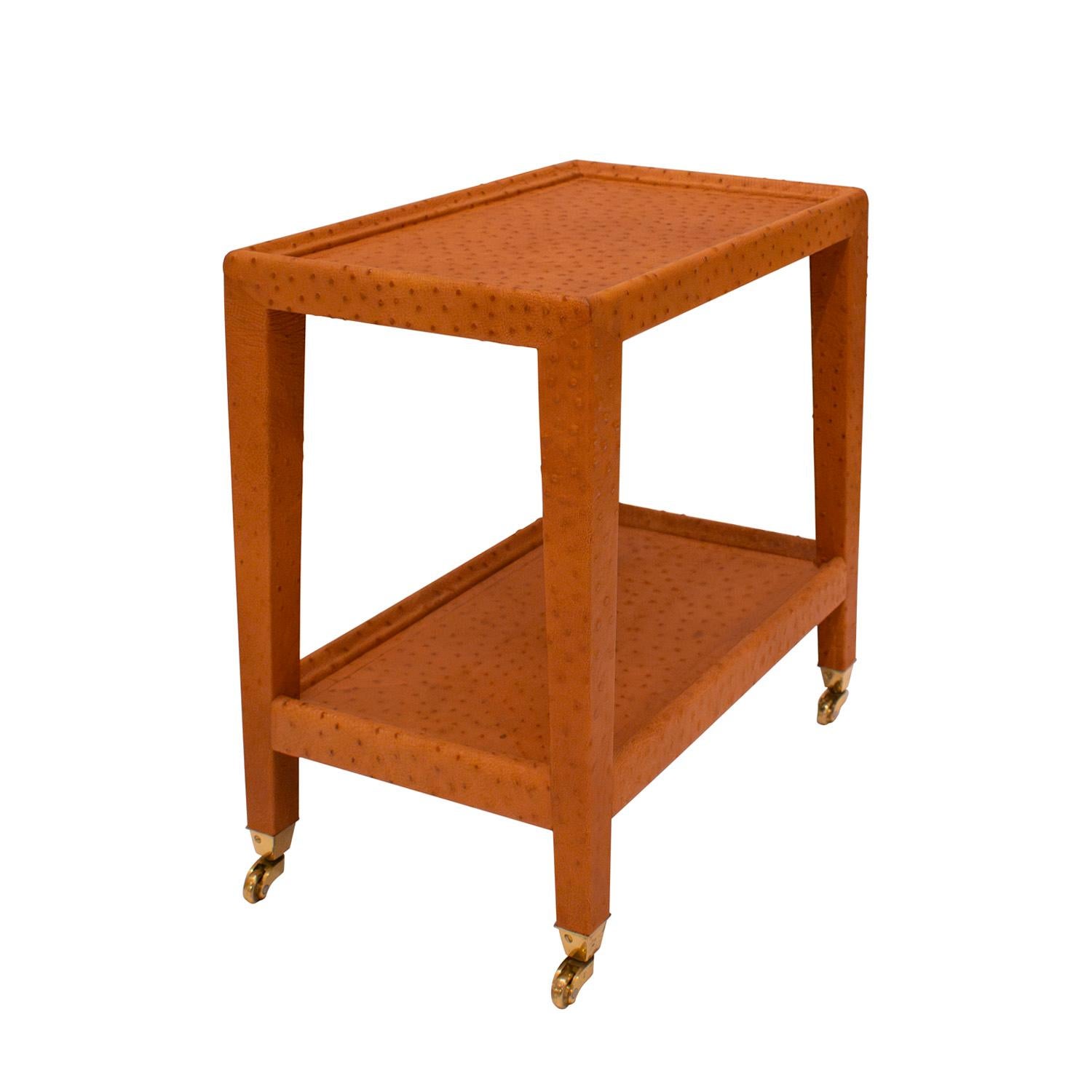 Unique prototype “Telephone Table” in camel ostrich skin with gently tapering legs and brass castors by Karl Springer, American 1980's. Telephone Tables were typically made with non-tapering legs.  This was a prototype created for Karl Springer in