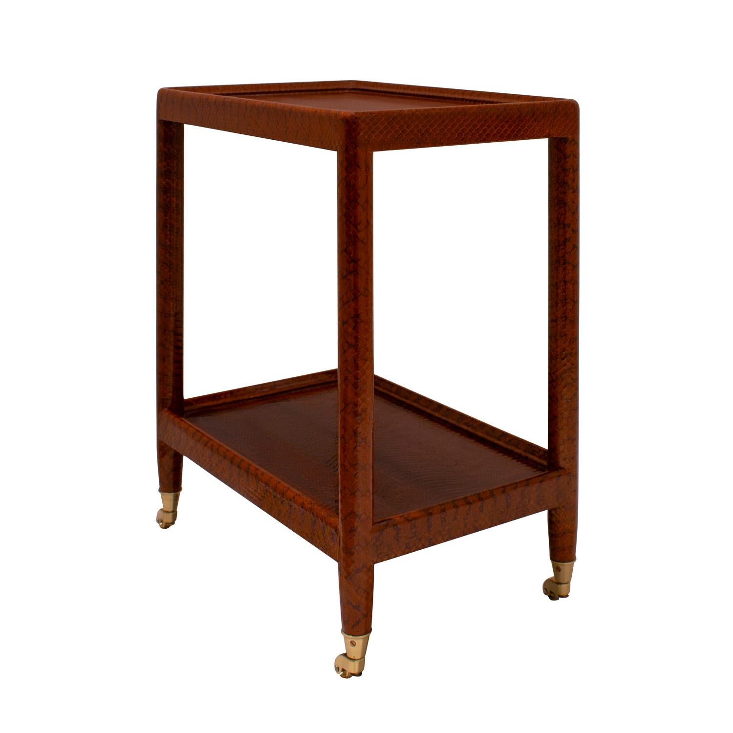 Unique prototype “Telephone Table” in chestnut color snake skin with round legs, brass castors, and moiré silk on bottom by Karl Springer, American 1980's. Telephone Tables were typically made with square legs. A small number of prototypes were