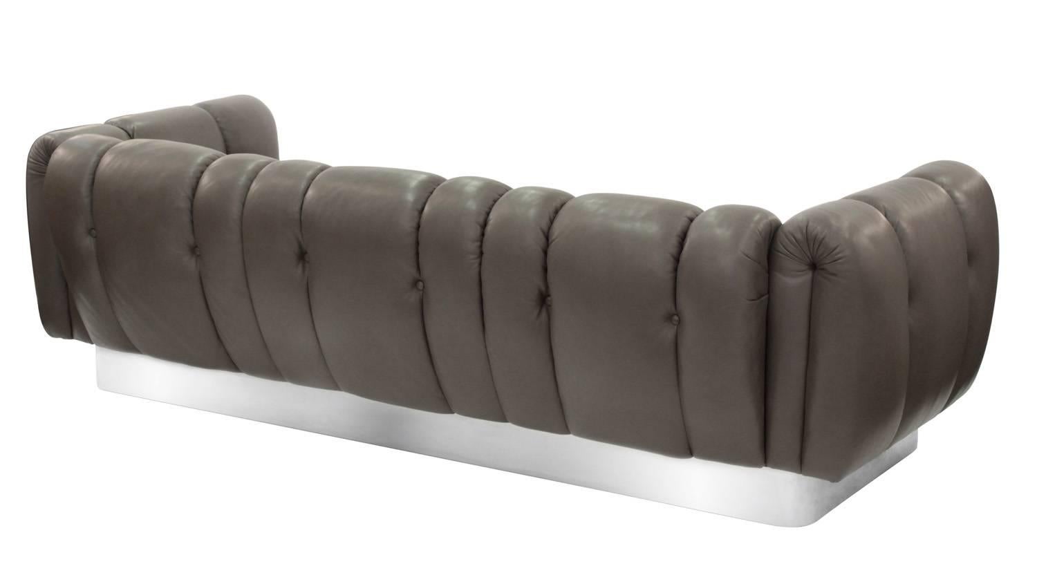 Sofa upholstered in channeled grey leather with steel base attributed to Leon Rosen for Pace Collection, American, 1970s.
           