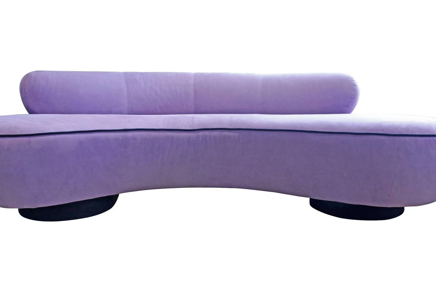 Serpentine sofa upholstered in lilac ultrasuede with black welting and bases in walnut and Lucite by Vladimir Kagan for Directional, American, 1990s (retains original directional label on bottom).