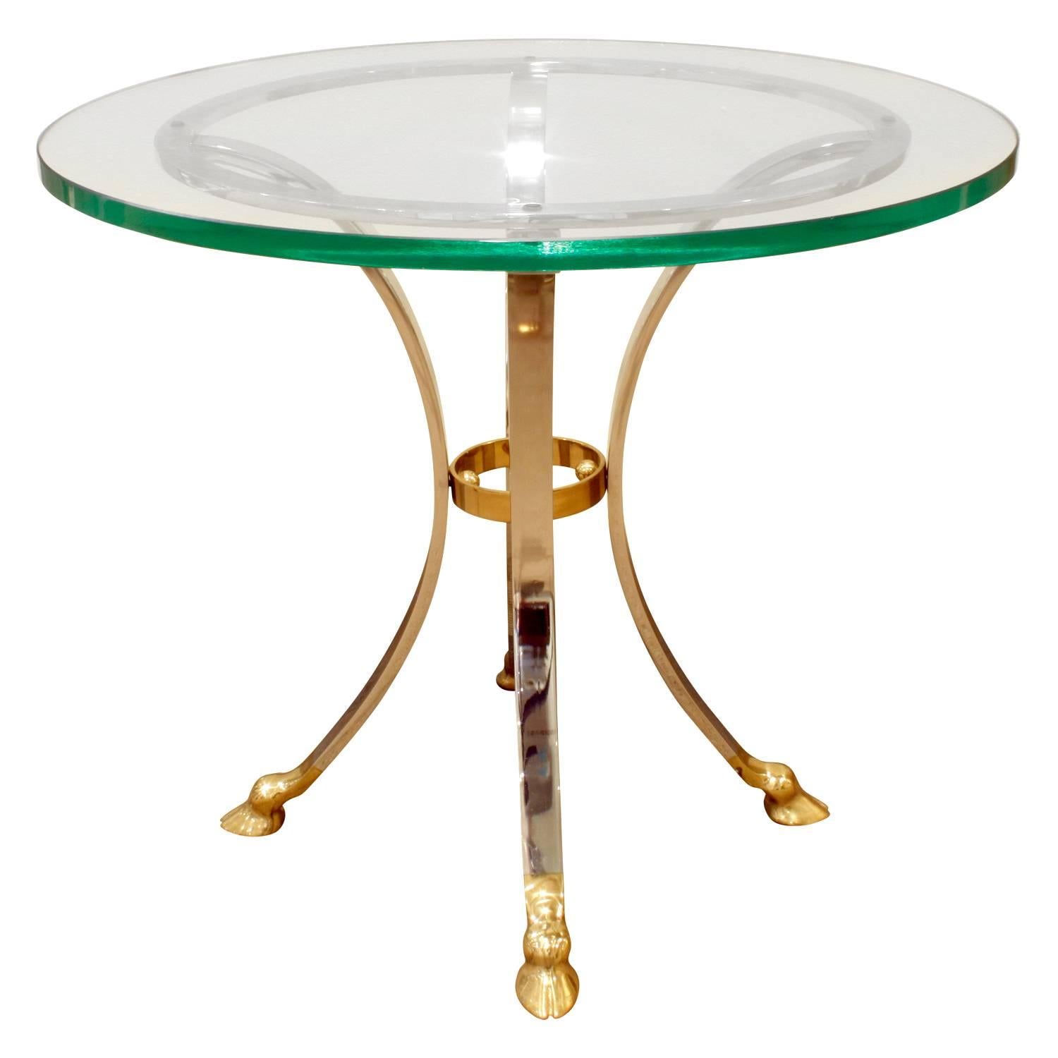 Neoclassical style end table with hoof motif in brass and steel with glass top, American, 1960s.