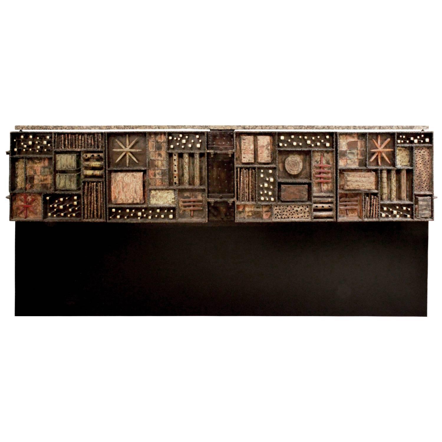 Forged front four-door cabinet in welded and patinated steel, color pigments, 24-karat gold leaf, painted wood with granite top by Paul Evans, American 1979. This piece comes with the original invoice from The Paul Evans Studio. It was designed for