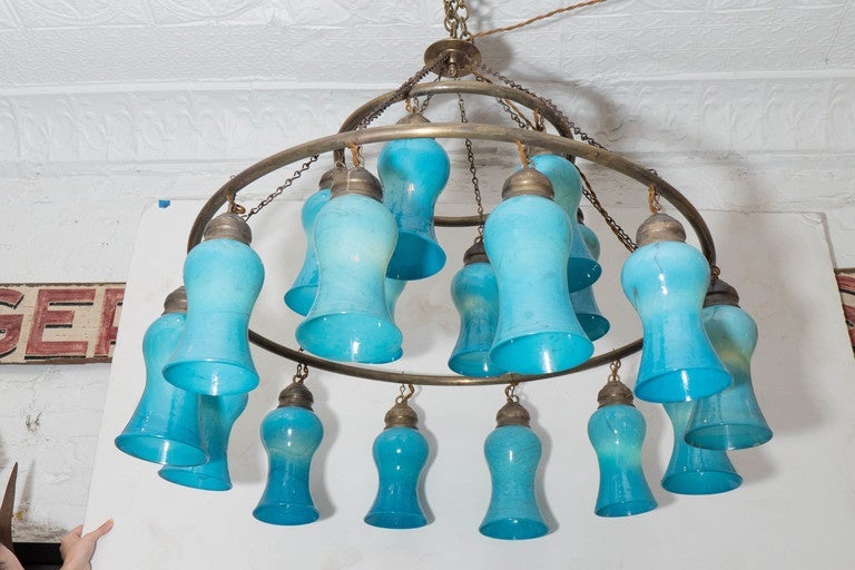 Two-tiered Egyptian chandelier with opaque Turquoise bell-shaped glass with brass ring. Available in custom sizes.