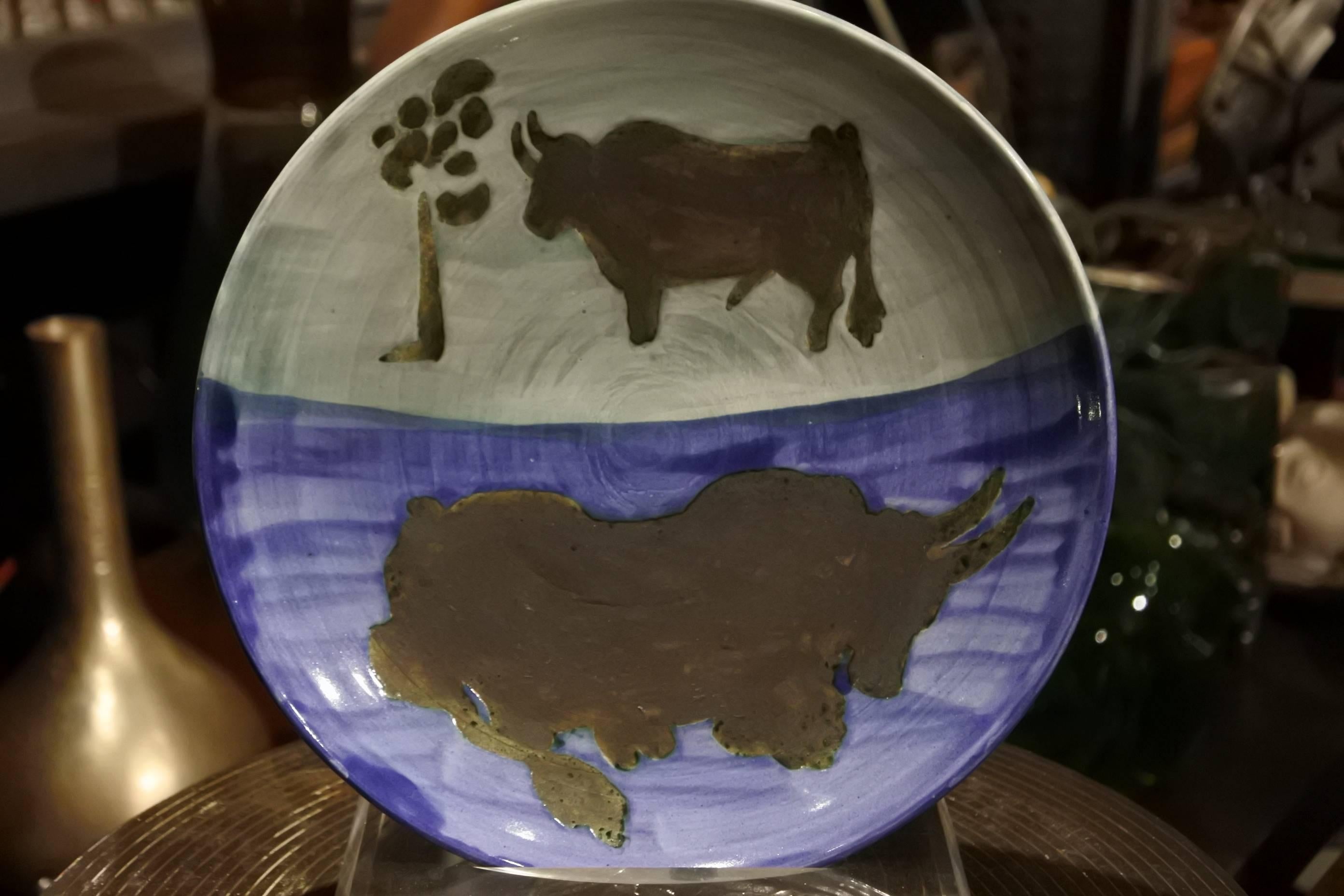 Plate from Picasso's time working with ceramics around the mid-1950s

Unusual color-way in this particular bull motif series, in excellent, original unrestored condition. 

No chips, cracks or blemishes present.



 