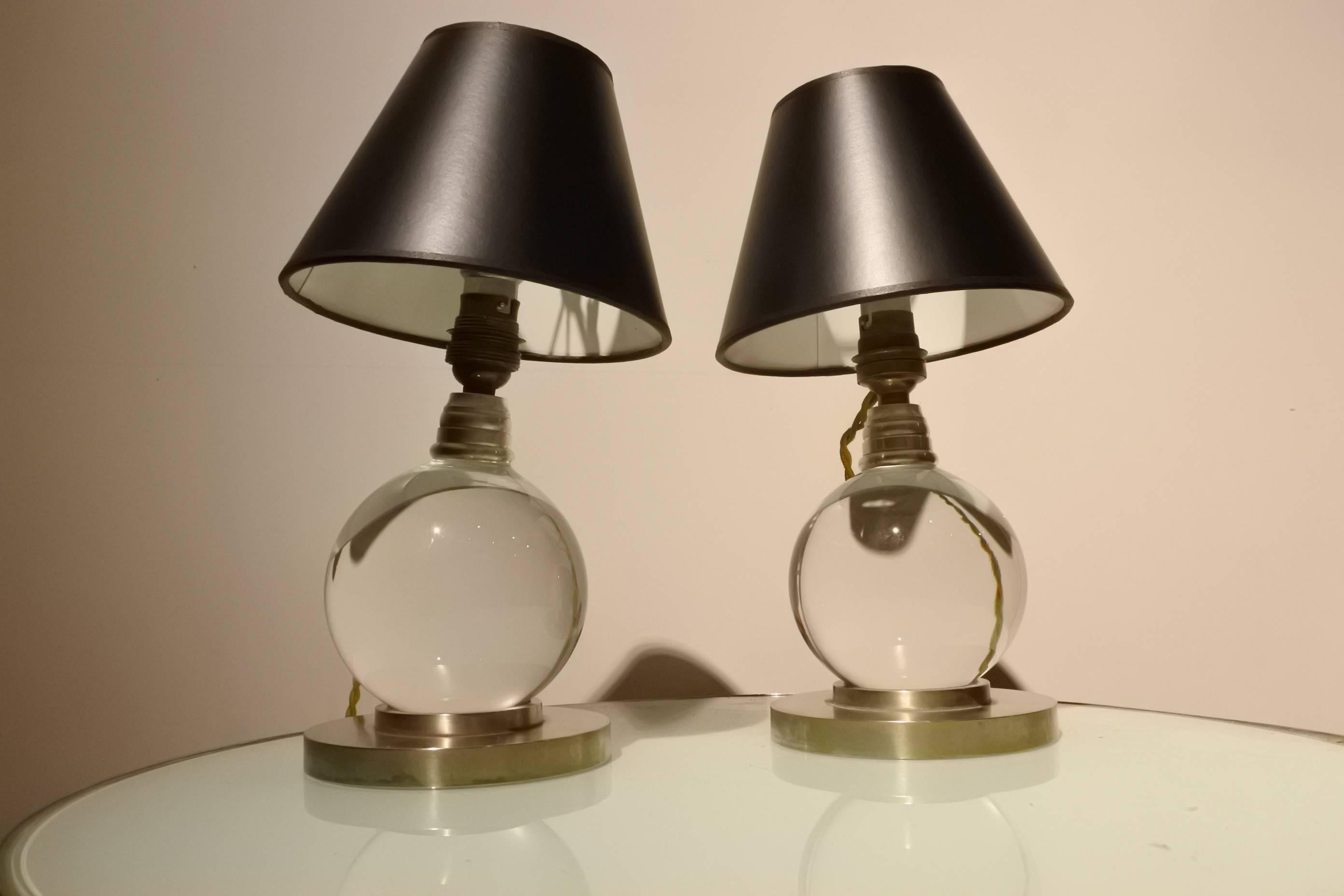 Rare pair of Adnet lamps made with Baccarat crystal and a nickel base. The balls can be moved to different positions. These lamps are from the 1940s and are documented in the Adnet book (model 7706).