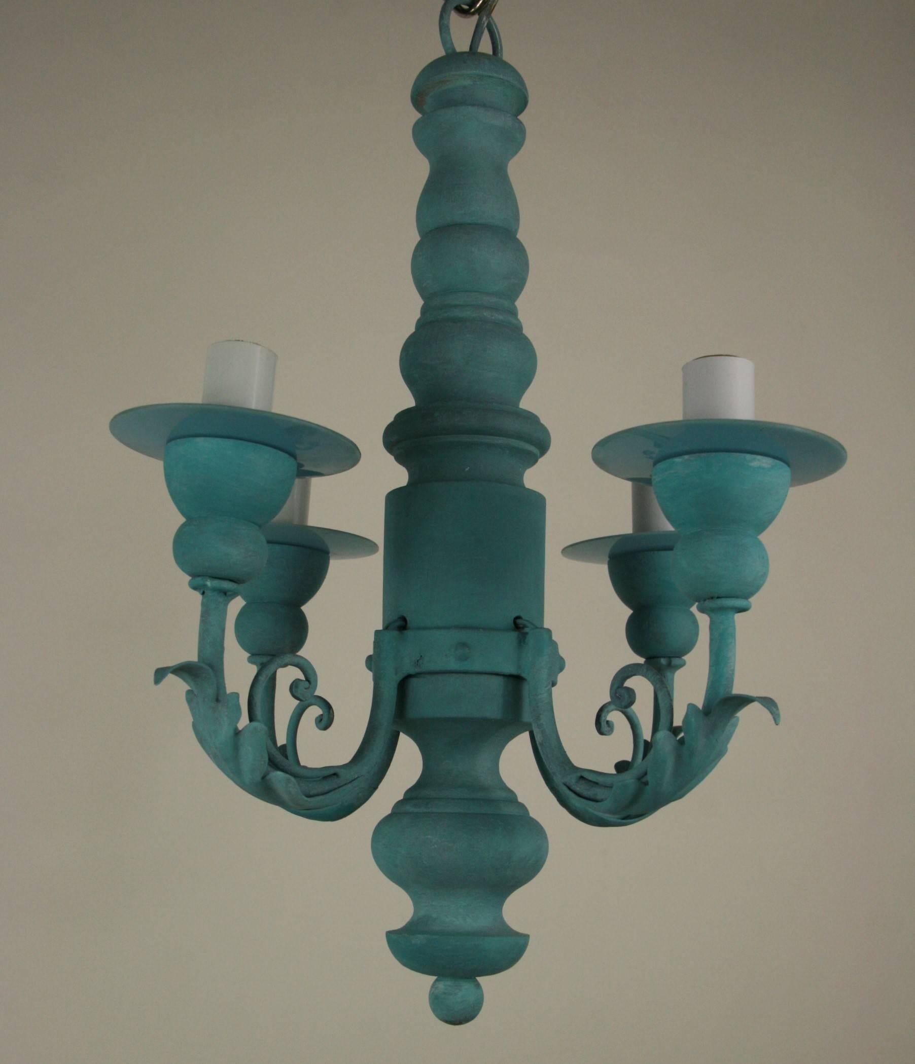 #1-2990, a hand-painted blue wood chandelier featuring four foliate arms ending with blue glass bobeches.
Newly rewired
Takes 4  60 watt max candelabra based bulbs