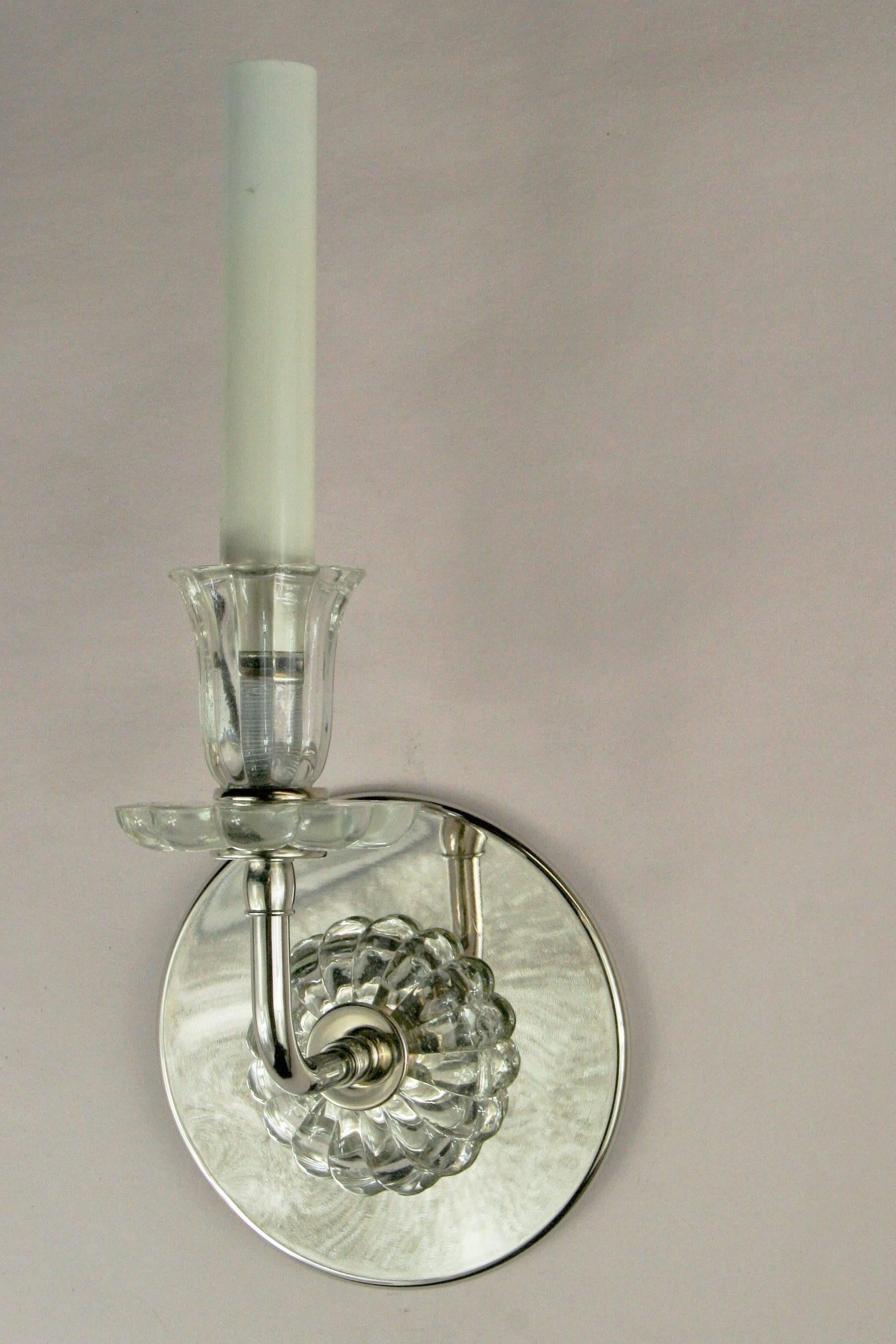 A pair of nickel single arm and tulips glass sconce. Newly rewired.