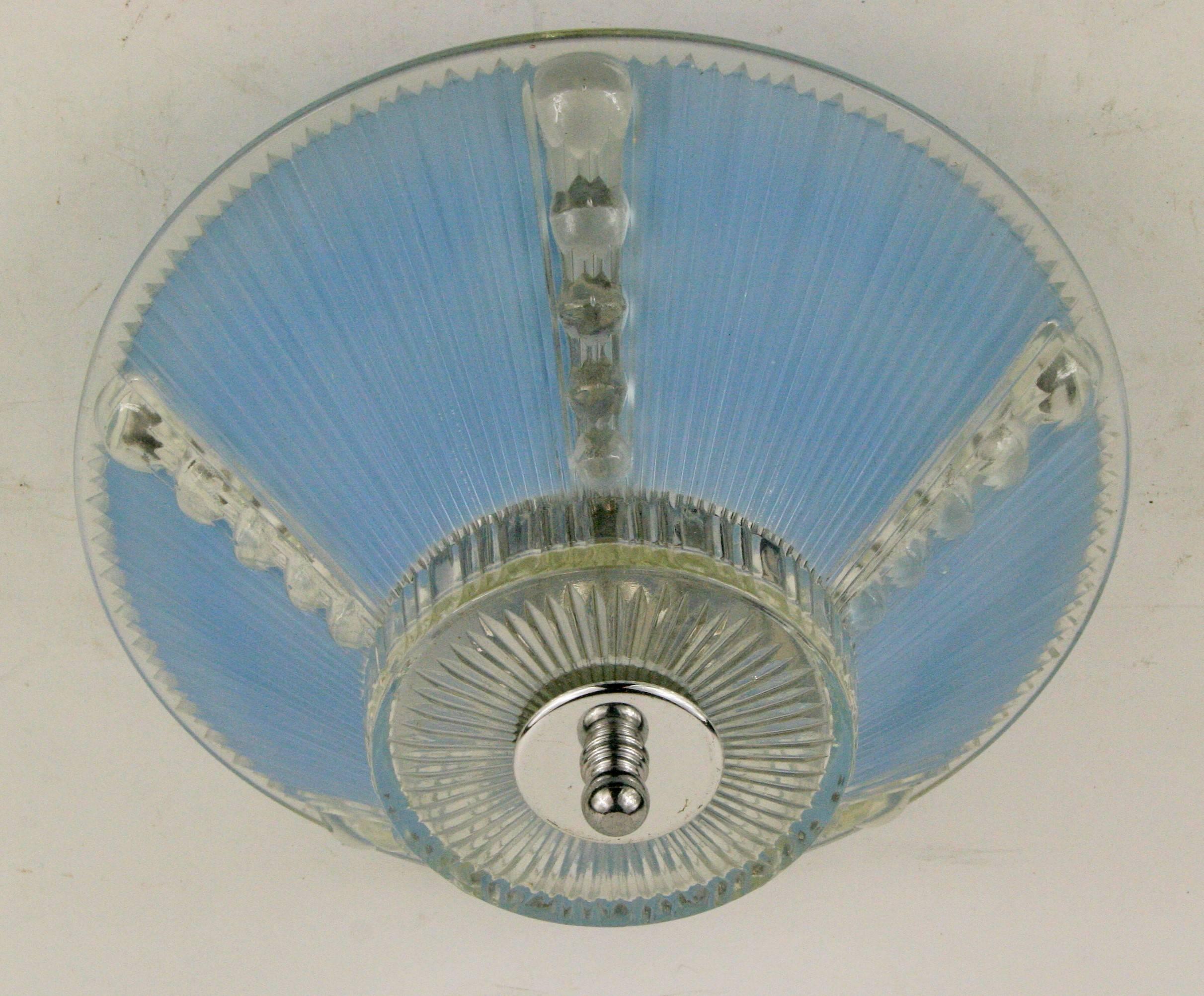 Pale blue glass flush mount.

#1-3001, a reeded pale blue whit clear bubble motif flush mount.
 Two internal 60 watt max candelabra based bulbs.
 Newly rewired.