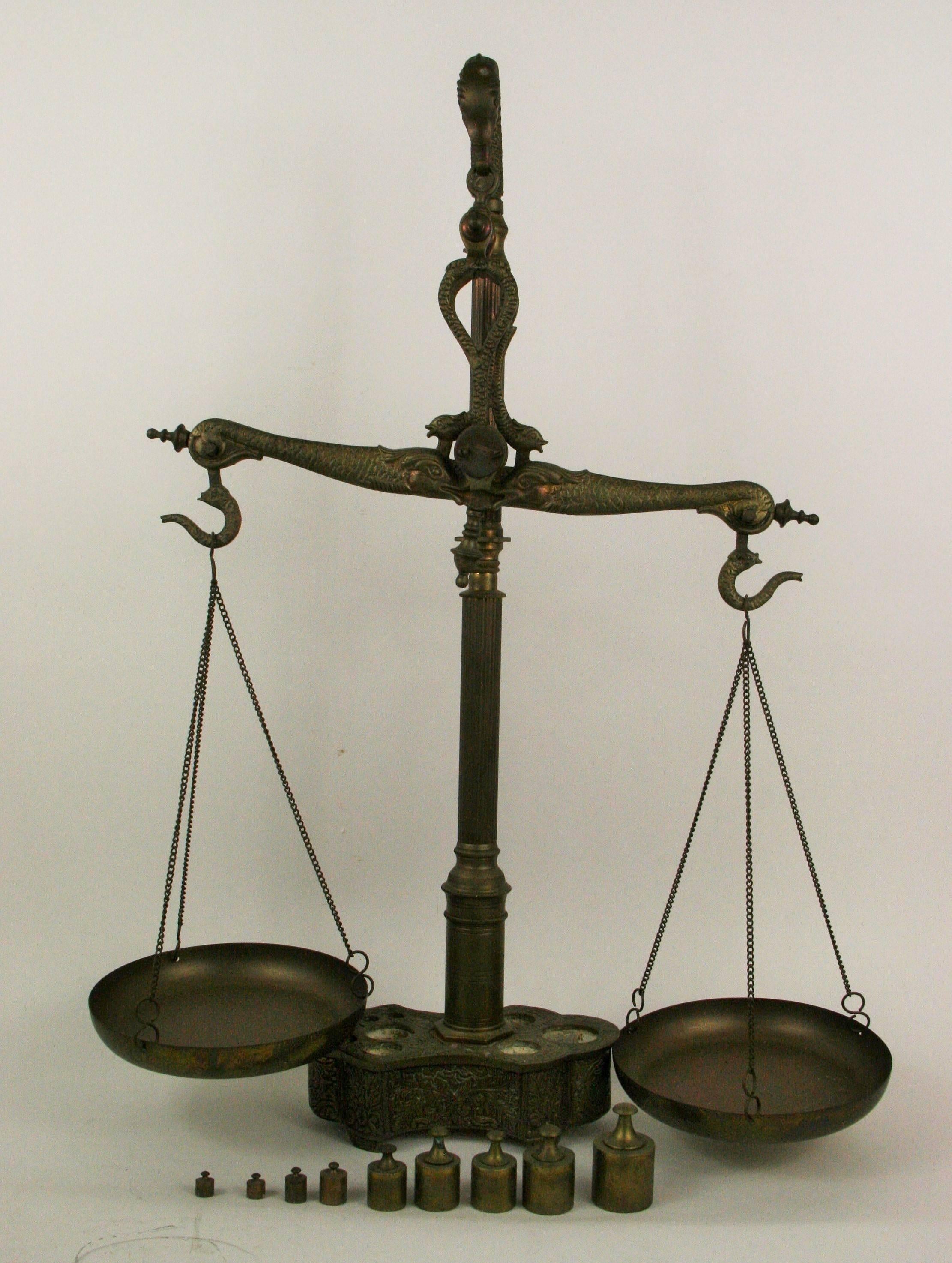 9-176 Intricately detailed brass balance scale with weights (weights fit in solid brass base) made in Portugal.