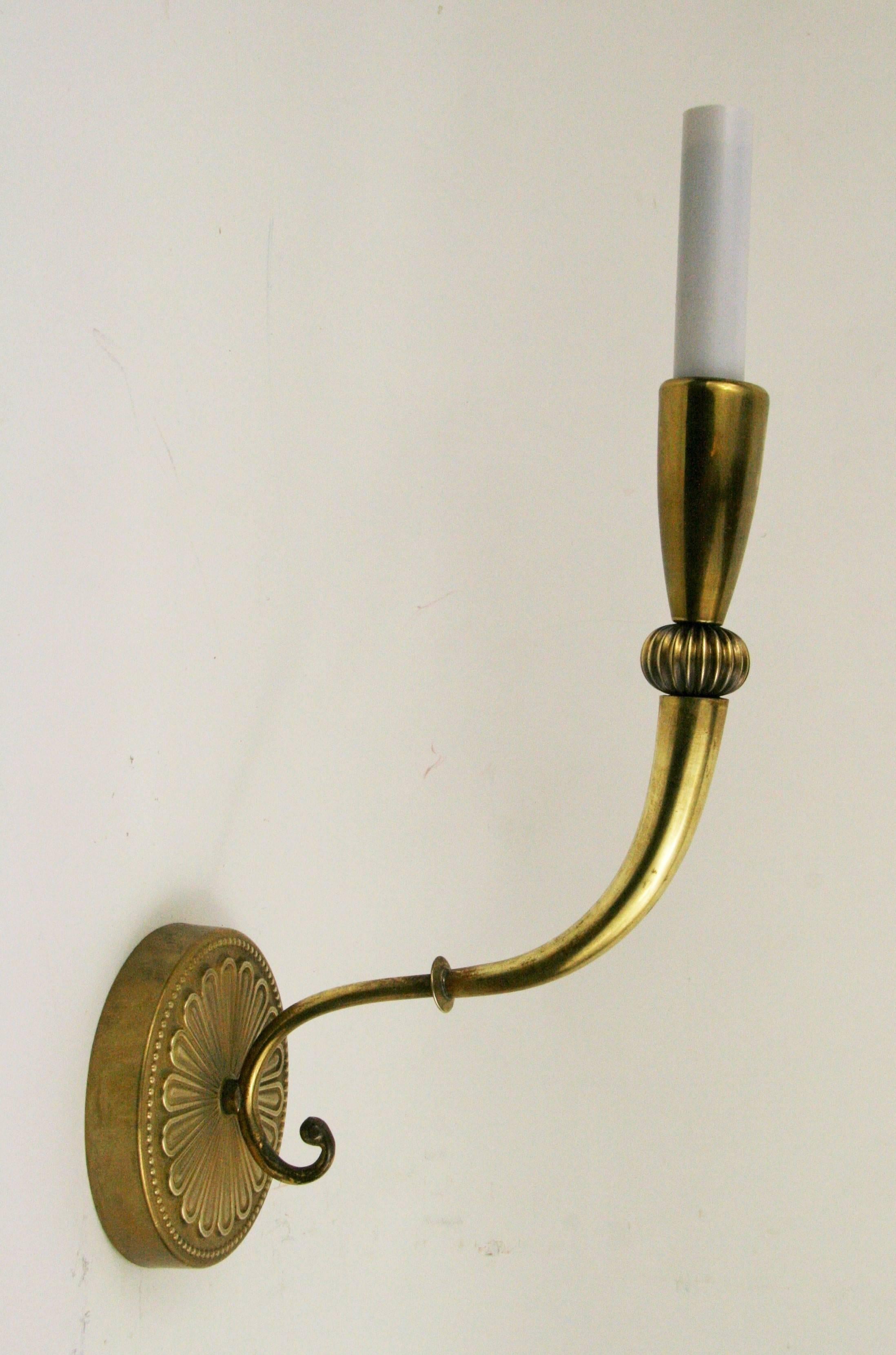 #2-1809, a pair of French fluted single arm brass sconce having a round foliate backplate,
candelabra base 60 W bulb.
Newly rewired.