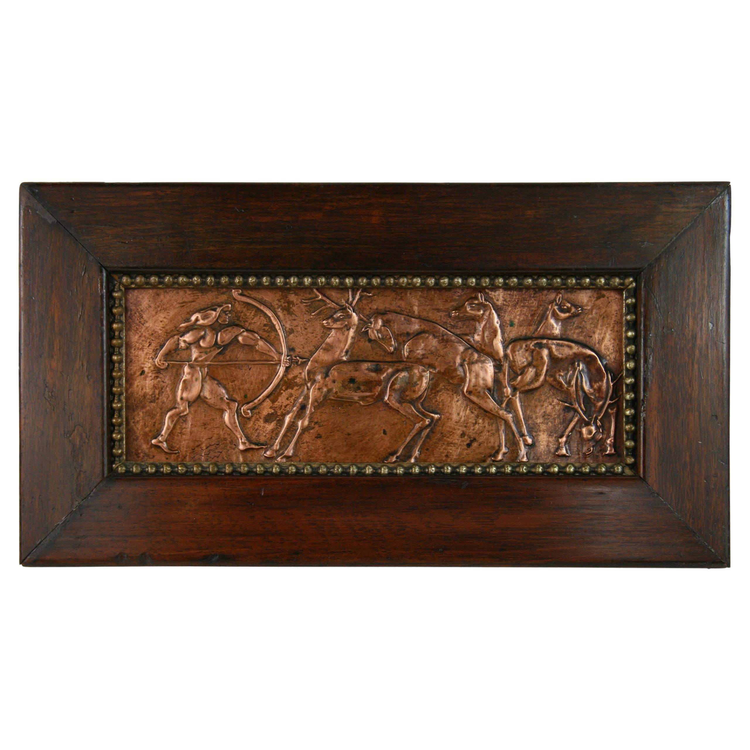 5-3627 hand hammered copper relief of mythical figure with bow and arrow.
Set in a vintage wood frame
Image size: 11 x 4