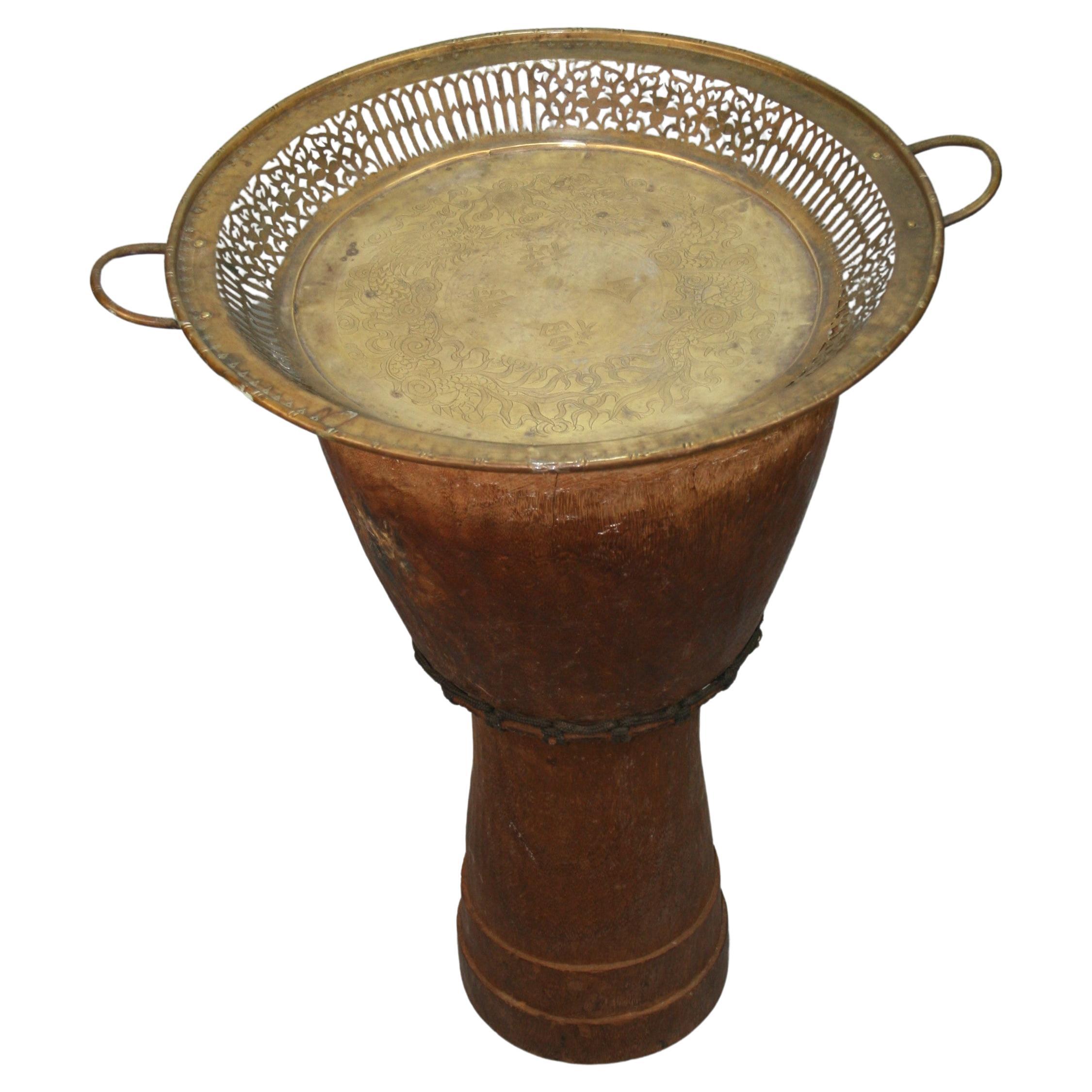 Japanese drum planter with latter added removable brass tray
Has metal and rope banding on middle.