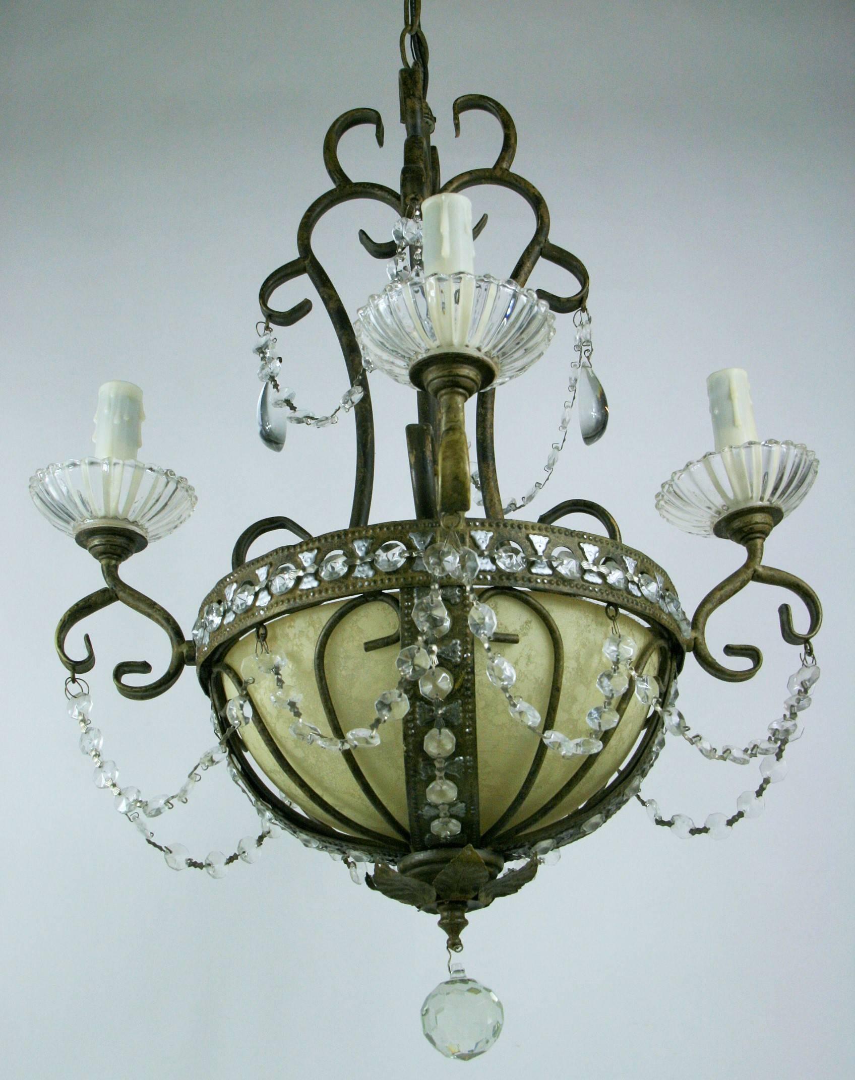 #1-2993, a four arm beaded crystal scrolled metal basket shaped chandelier having a glass alabaster like dome with two internal light bulbs.
Takes six candelabra base bulbs 40 watt max.