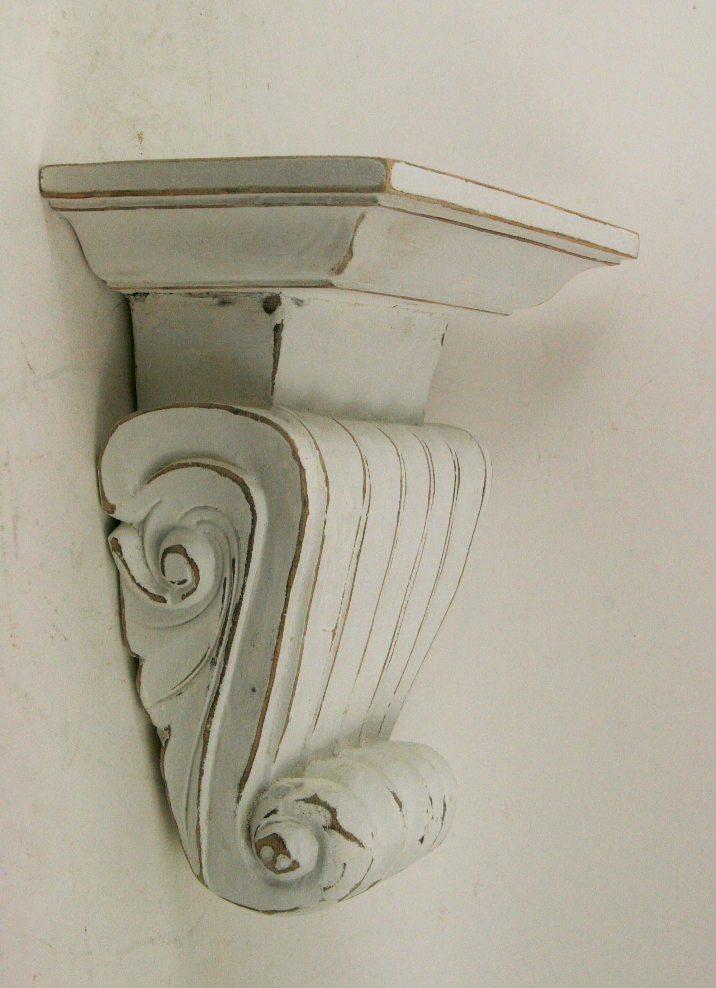 Pair of large hand-carved Italian  wood wall shelves in a distressed white finish. Hanging hardware on back.
