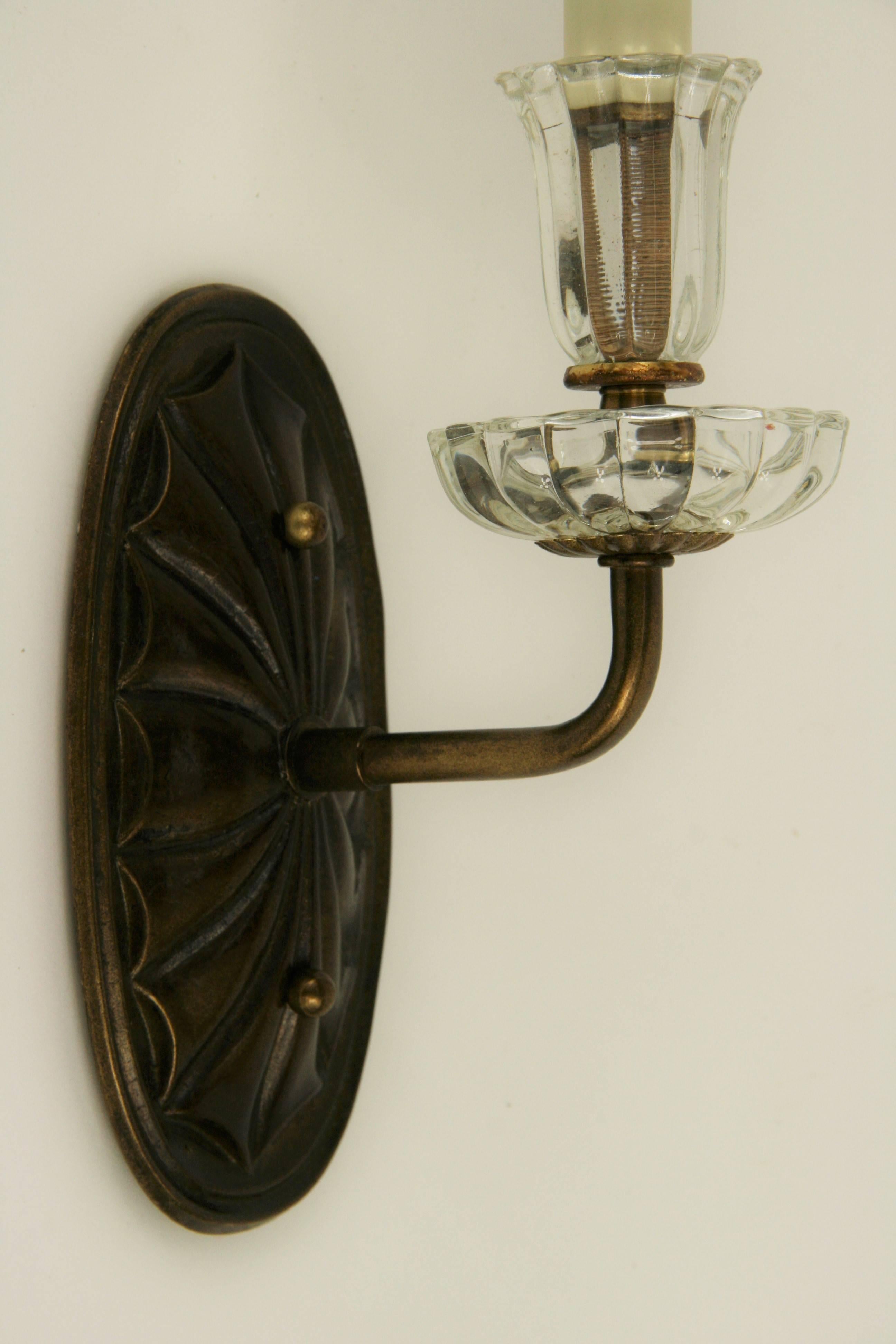 #2-1826 a pair of darkned brass foliate backplate supporting a single arm ending with glass tulip bobeche.
Newly rewired.