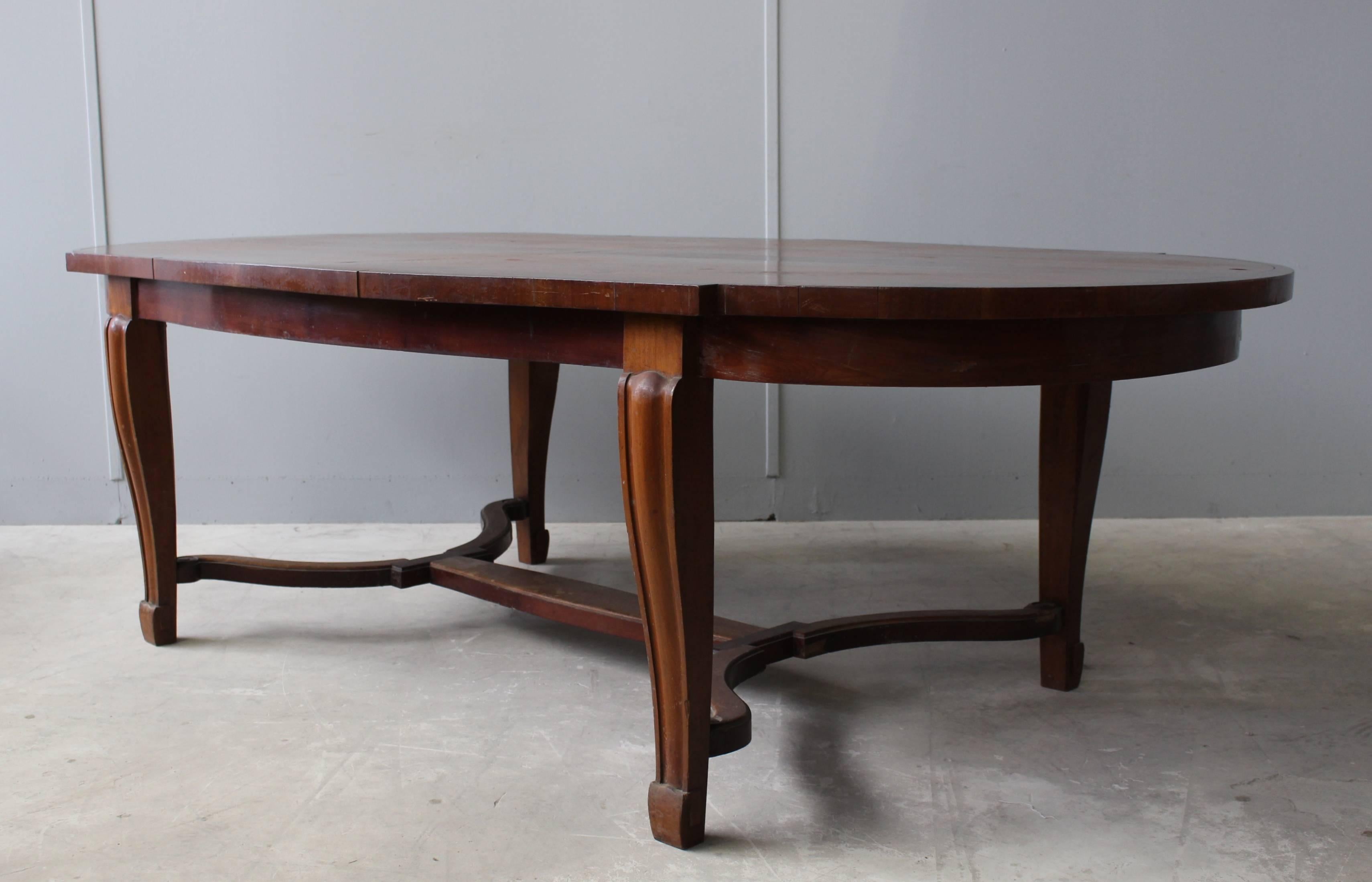 A fine French Art Deco mahogany dining table in the manner of Arbus.
A matching console with a marble top is also available. 
