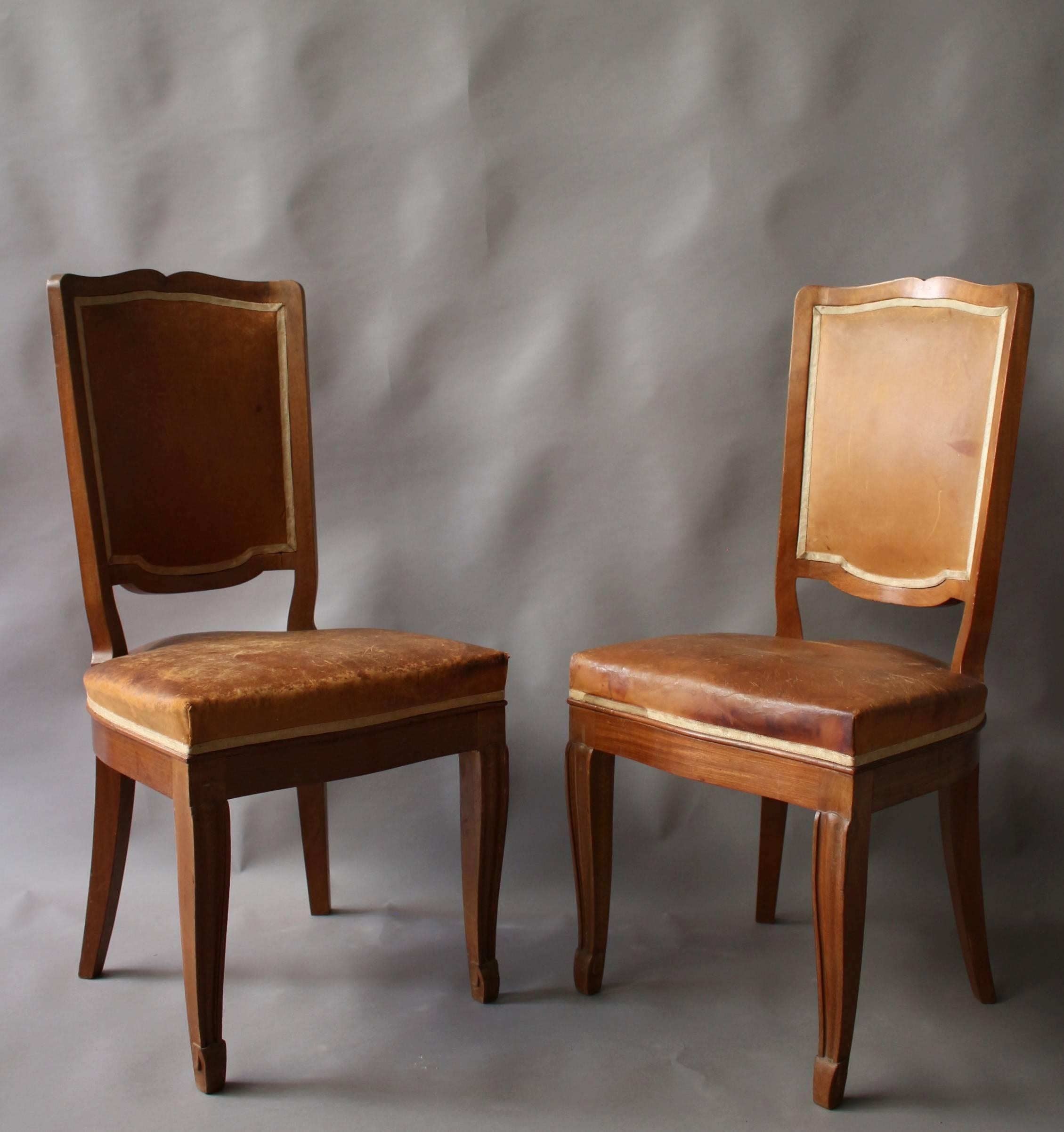 A set of 12 fine French Art Deco mahogany dining/side chairs, with carved details, in the manner of Andre Arbus. Refinishing in process.
A matching dining table and console are also available (see pictures) 
 